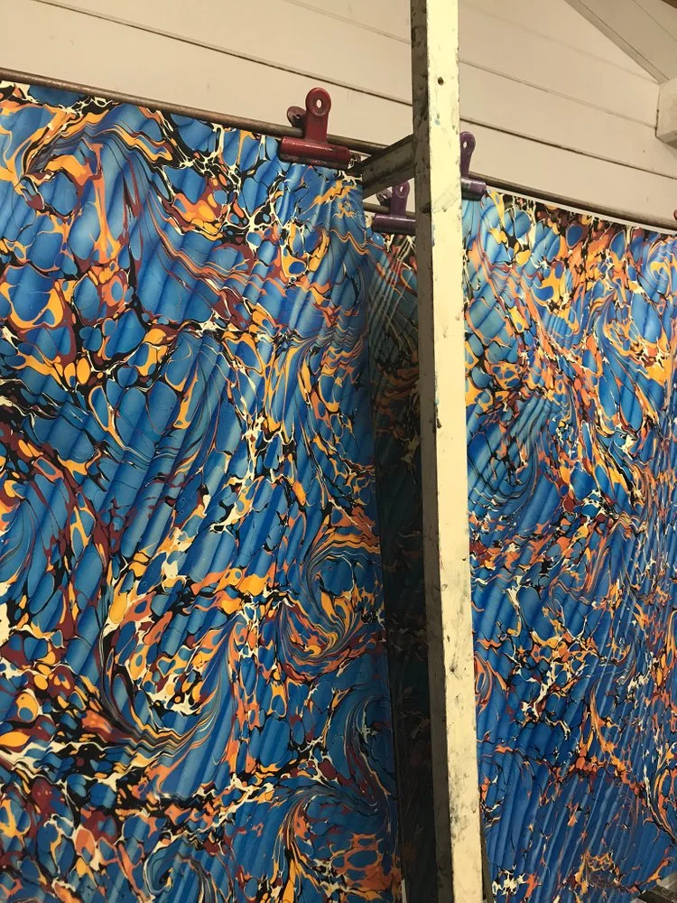 Large blue marbled sheets hang to dry in Jemma Lewis’ garden workshop.