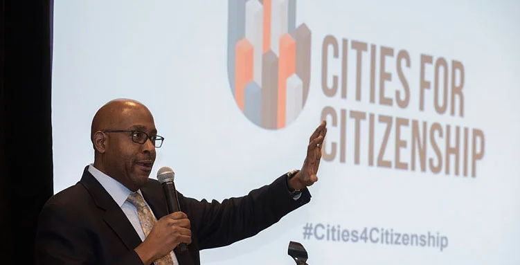 Chair of Arlington County Board, Christian Dorsey, welcomes attendees at the Cities for Citizenship (C4C) Municipal Gathering, and announces that Arlington County will join the C4C network. Photo: Carolina Kroon