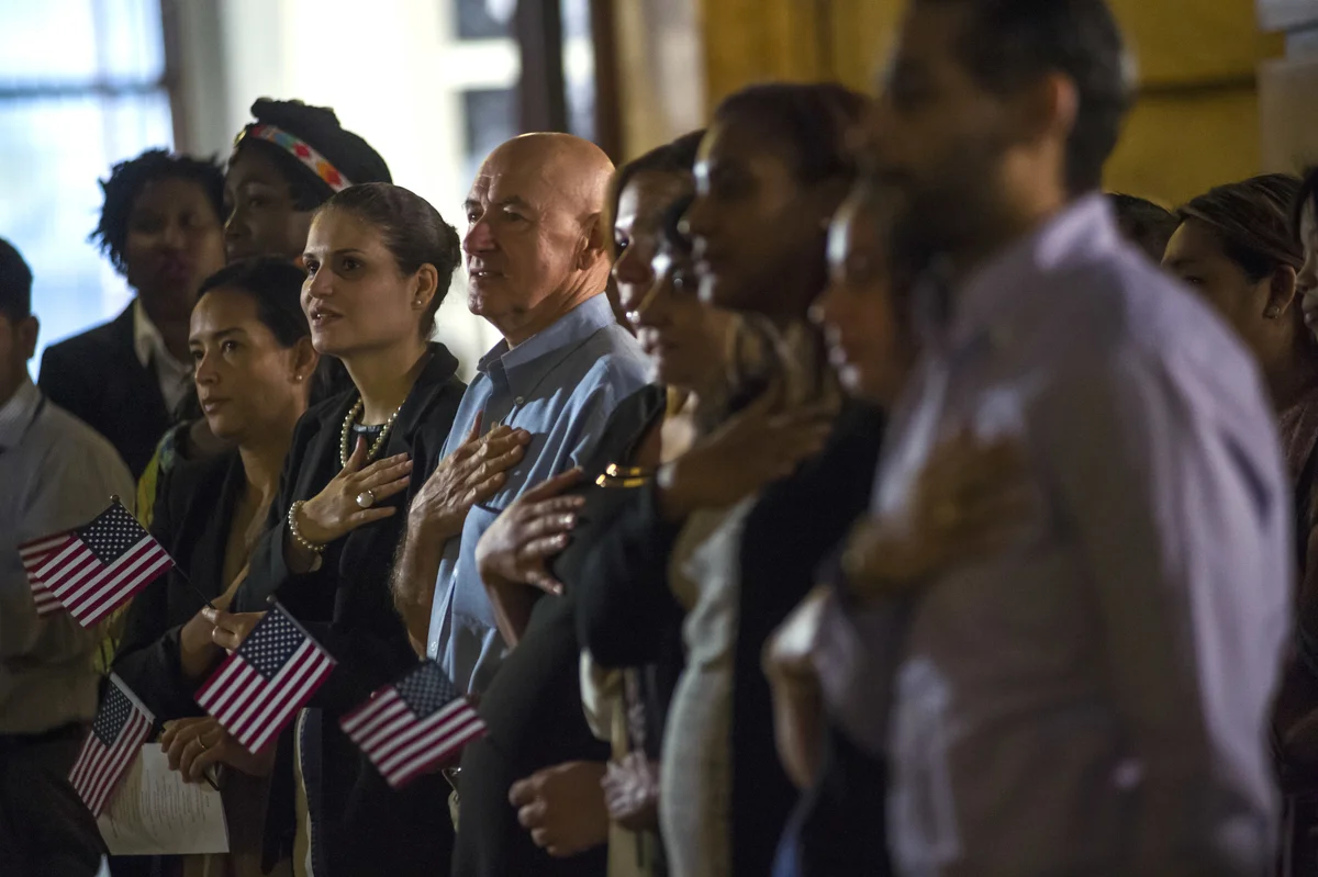 Naturalized citizens from across the world take their oath at a local oath ceremony