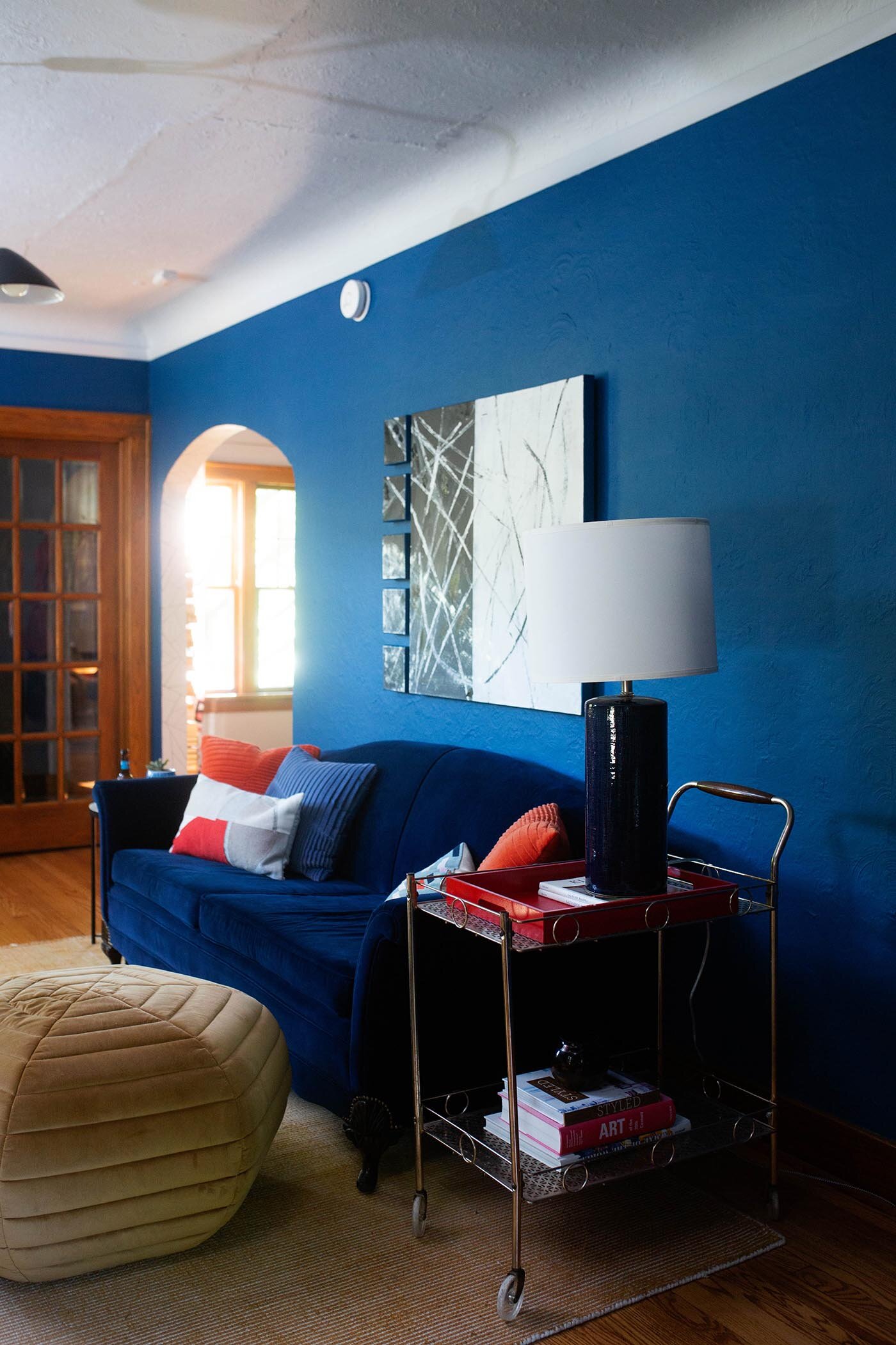 7 Blue velvet couch modern art blue walls regatta sherwin williams bar cart as end table.jpg