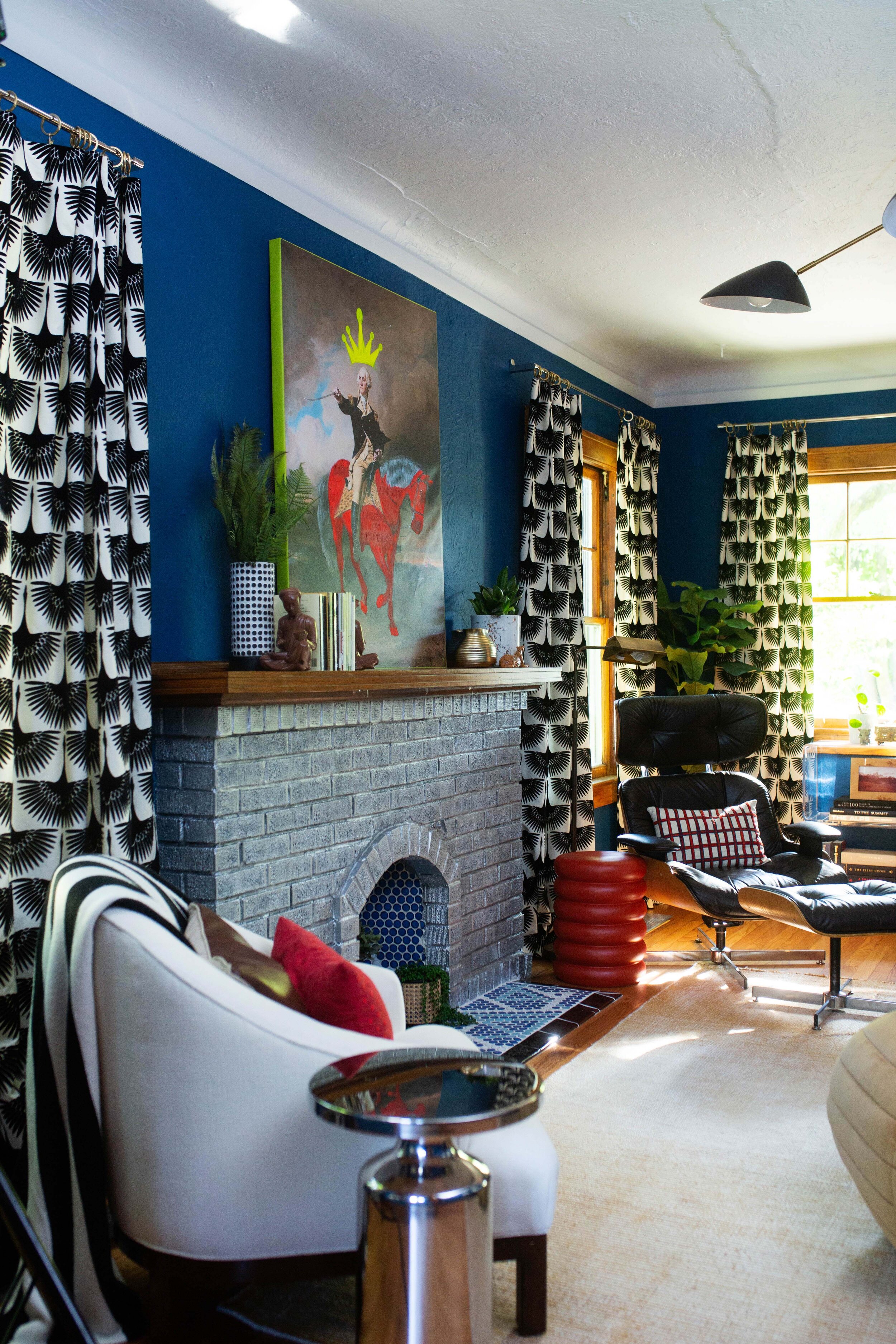 1 Blue room regatta Sherwin Williams black and white curtains silver metallic brick fireplace blue white modern penny tile design eames chair by fireplace.jpg