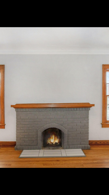 Grey brick fireplace with wood trim turned into silver fireplace wood trim blue walls.PNG