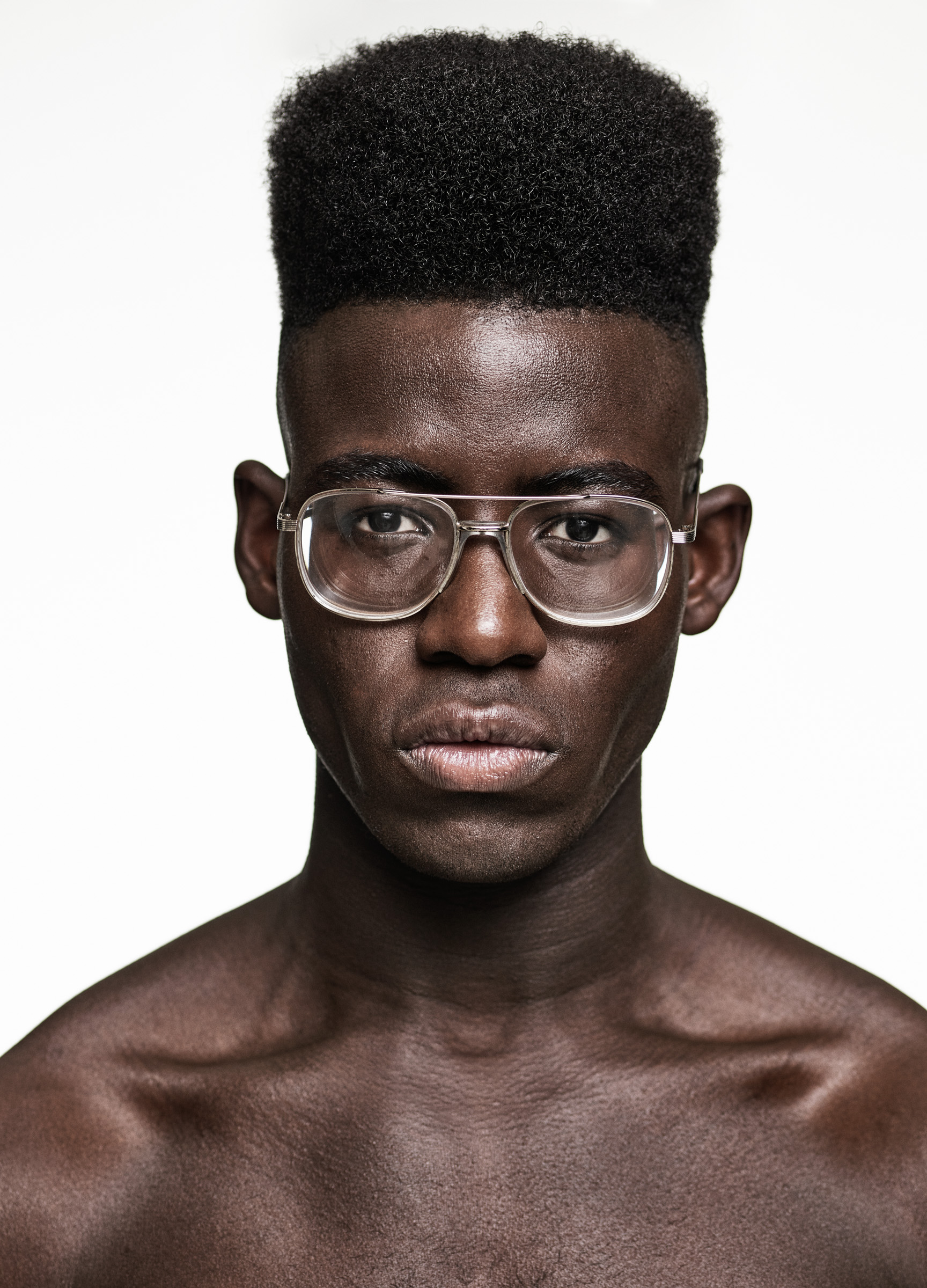A black man with a flat top hair style by Hooker and Young