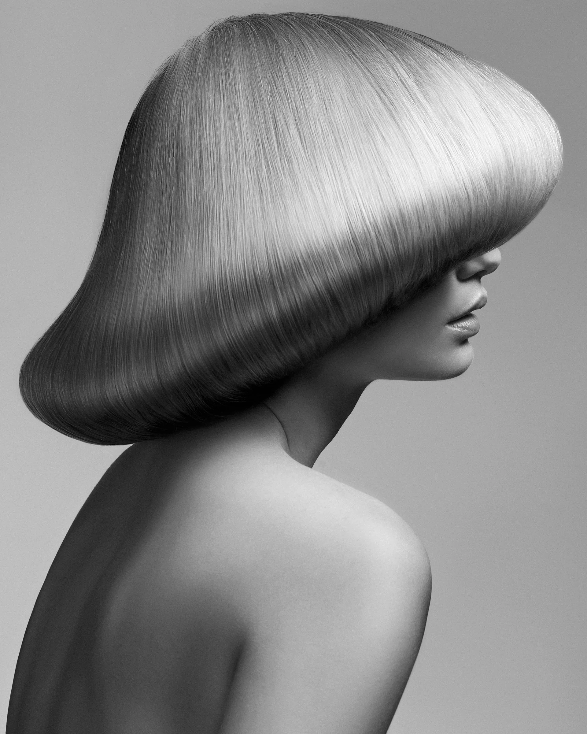 Nude woman with domed shiny blonde hair style 