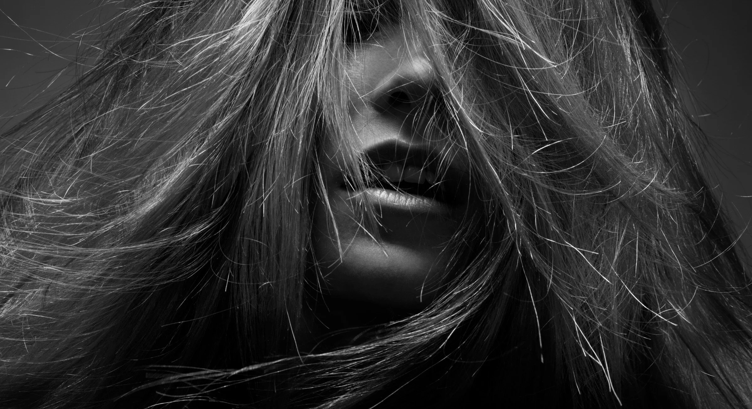 Woman in photography studio with long hair covering her face