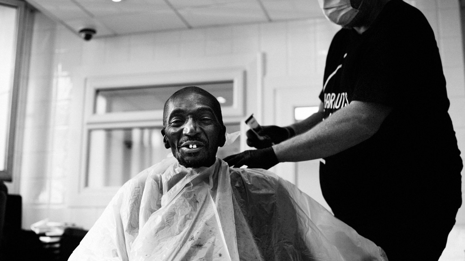 Barber Giving Haircut to Homeless