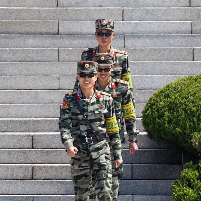 North Korean soldiers outside the Panmungak pavilion seen from the truce village of Panmunjom in the demilitarized zone in Paju, South Korea. #onassignment @bloombergbusiness #northkorea #southkorea #korea #soldiers #dmz #panmunjom #photojournalism #