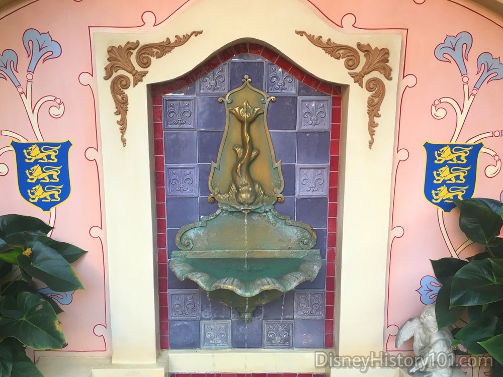  The patio’s water feature contains an antique fountainhead purchased by Lillian Disney, flanked by the Disney family crest and French Fleur-de-lis accents.  