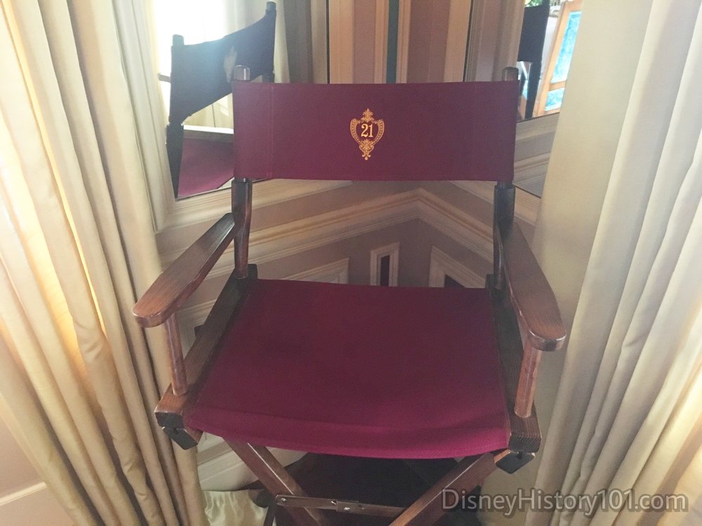 Director’s chair bearing the 21 Royal emblem, similar to director’s chairs in other private Disneyland clubs.