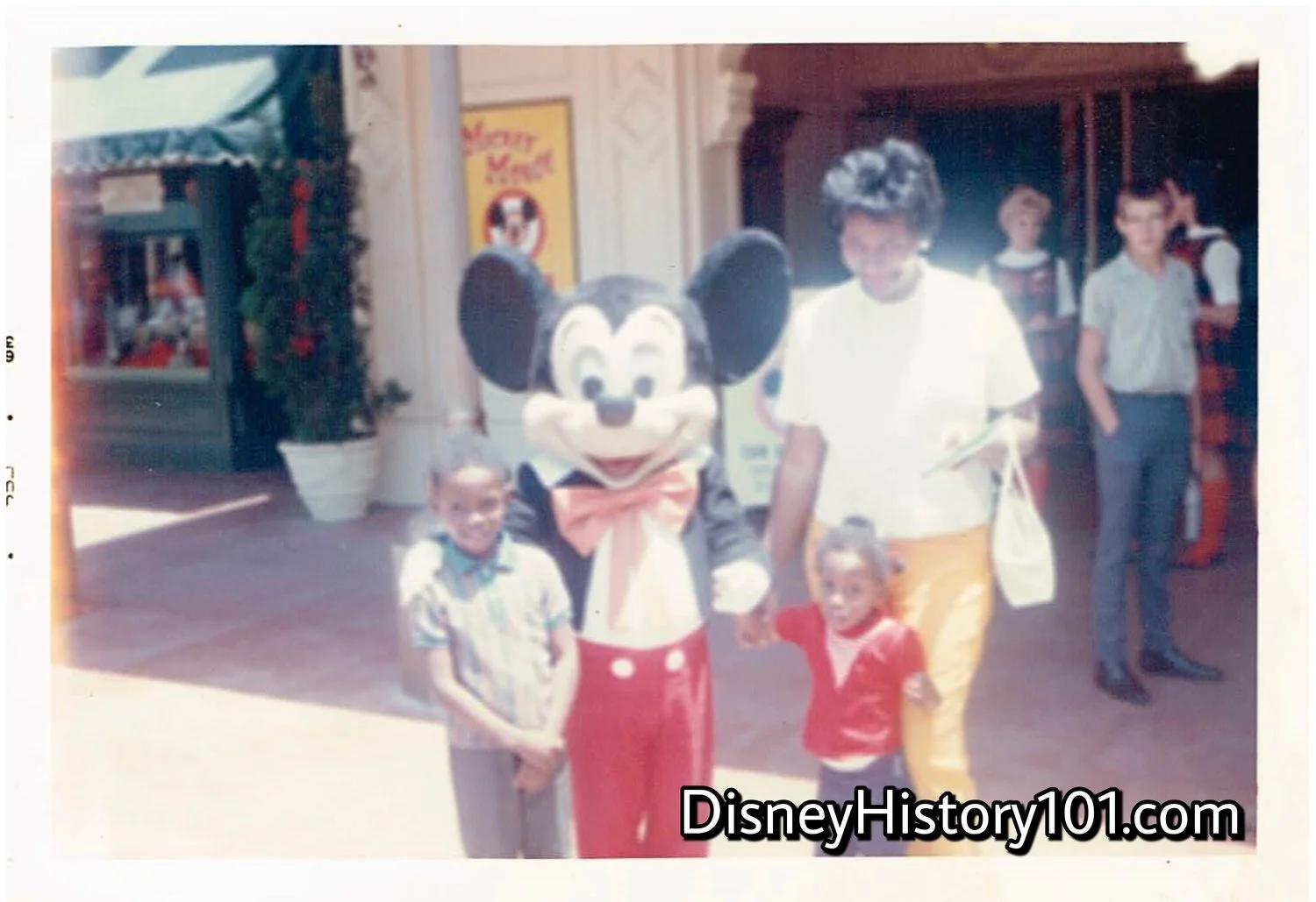 Mickey and Guided Tour Hostesses welcome guests to “The Mickey Mouse Club Headquarters” at Disneyland, in 1964