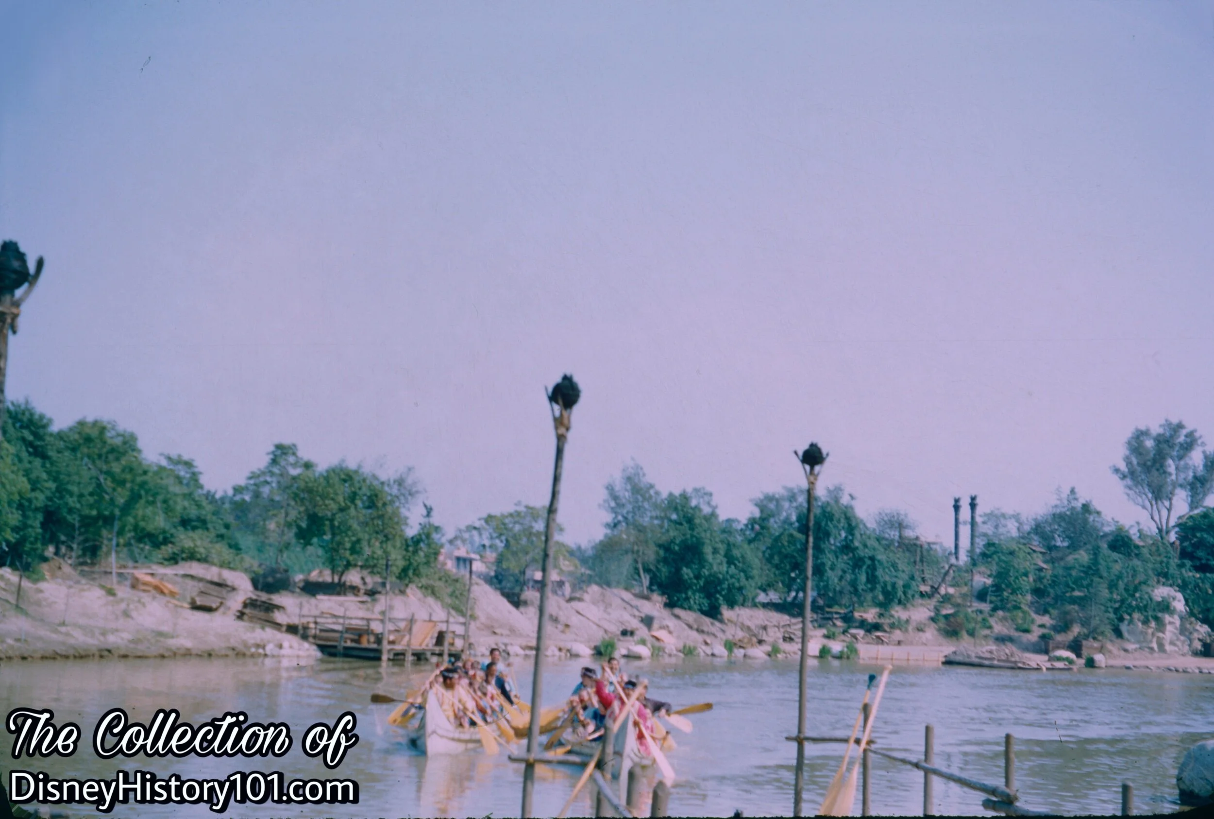 A pair of canoes, Guides, and guests return to the Indian War Canoe Dock, (1957)