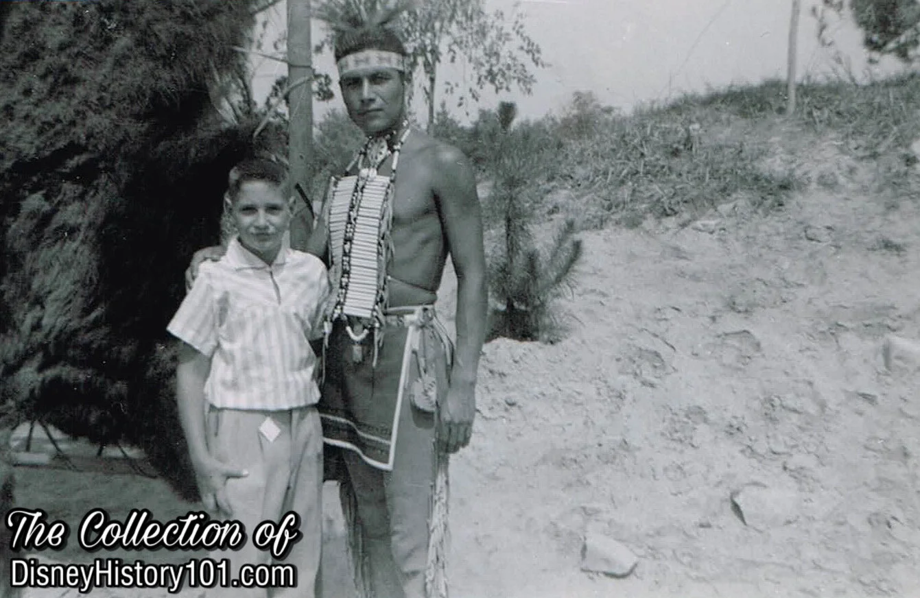 Vincent St Cyr meets a young guest in the original Indian Village, (c. 1955-1956)