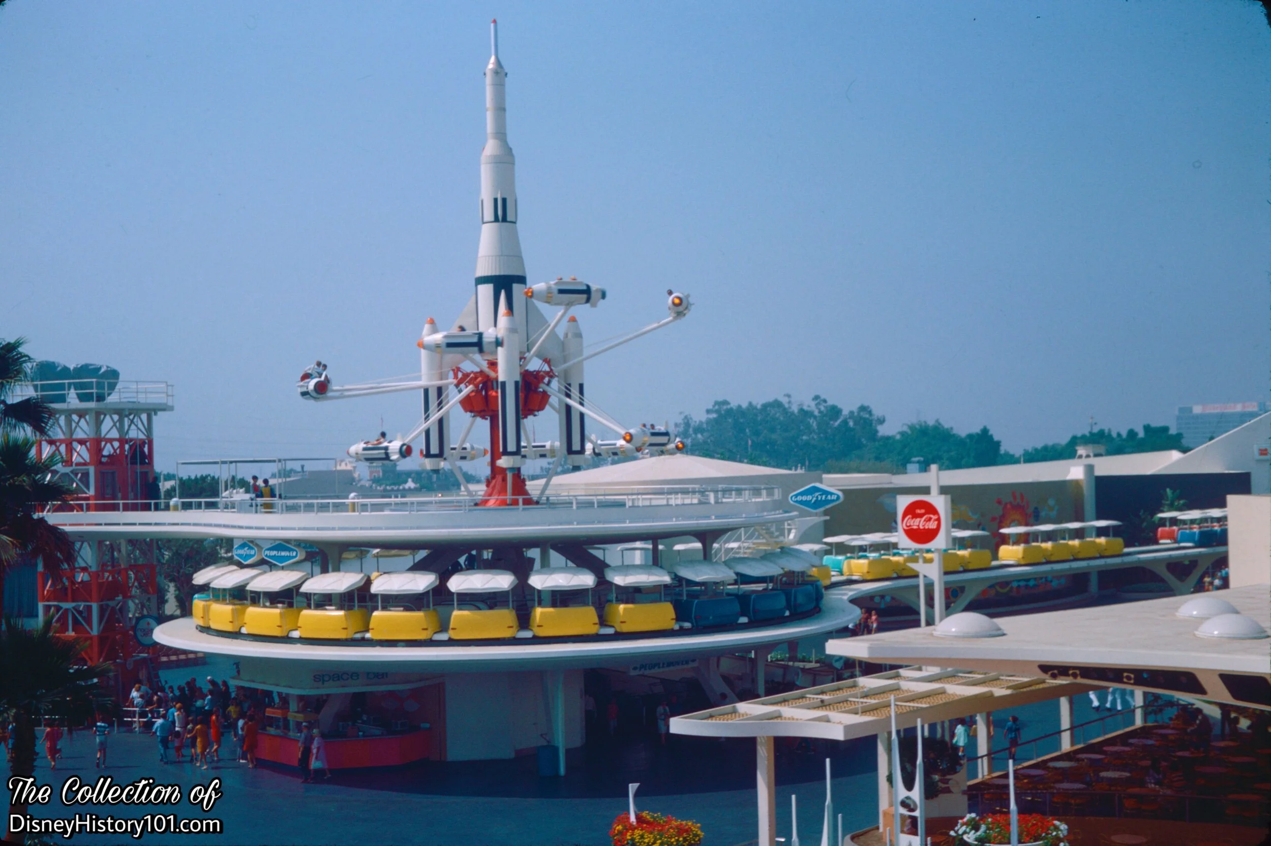  This is where your journey aboard the  PeopleMover  begins - at the  PeopleMover Loading Platform , above the  Space Bar  in  Tomorrowland !  This tri-level PeopleMover Station was at Tomorrowland’s  “theme center and pivotal point”  (according to “