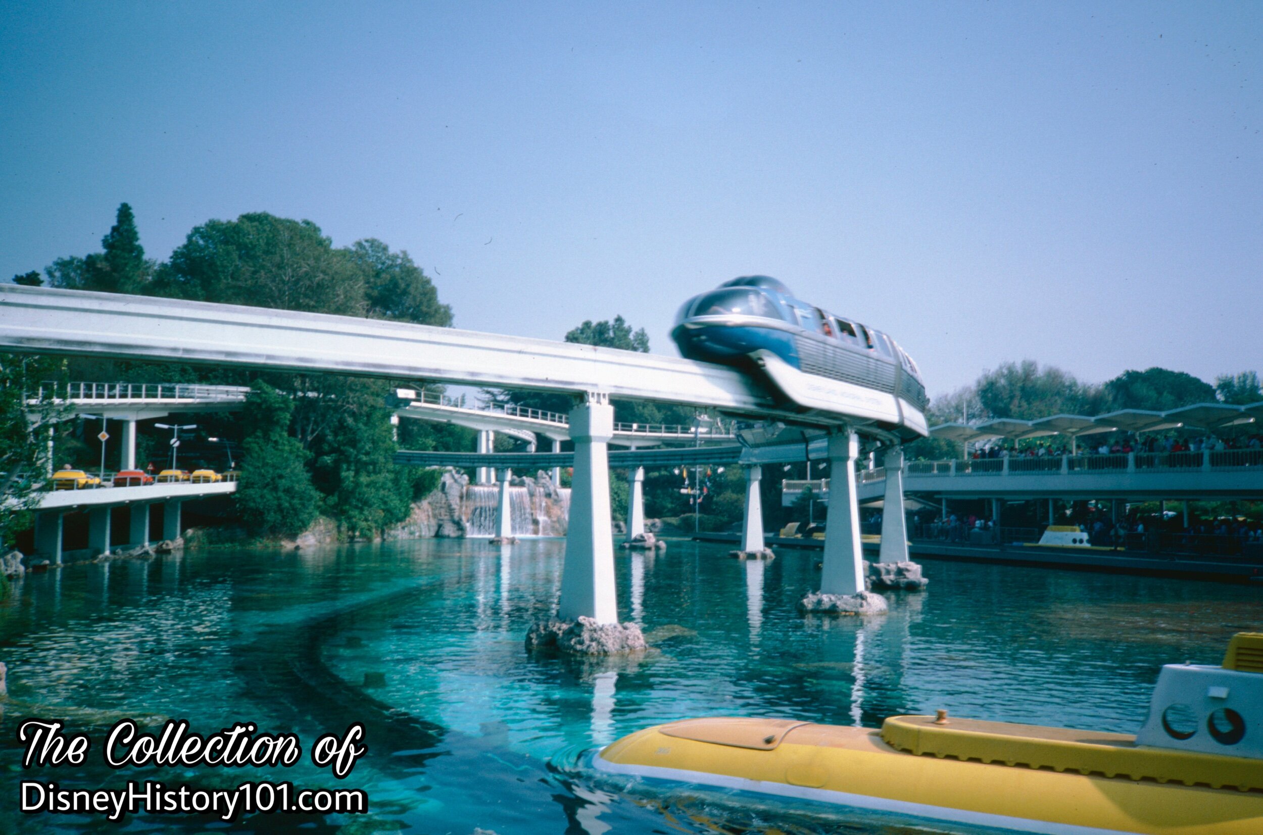 REENTERING THE PARK AND TOMORROWLAND SEGMENT - Monorail Mark V passing over the Submarine Lagoon, (1985)