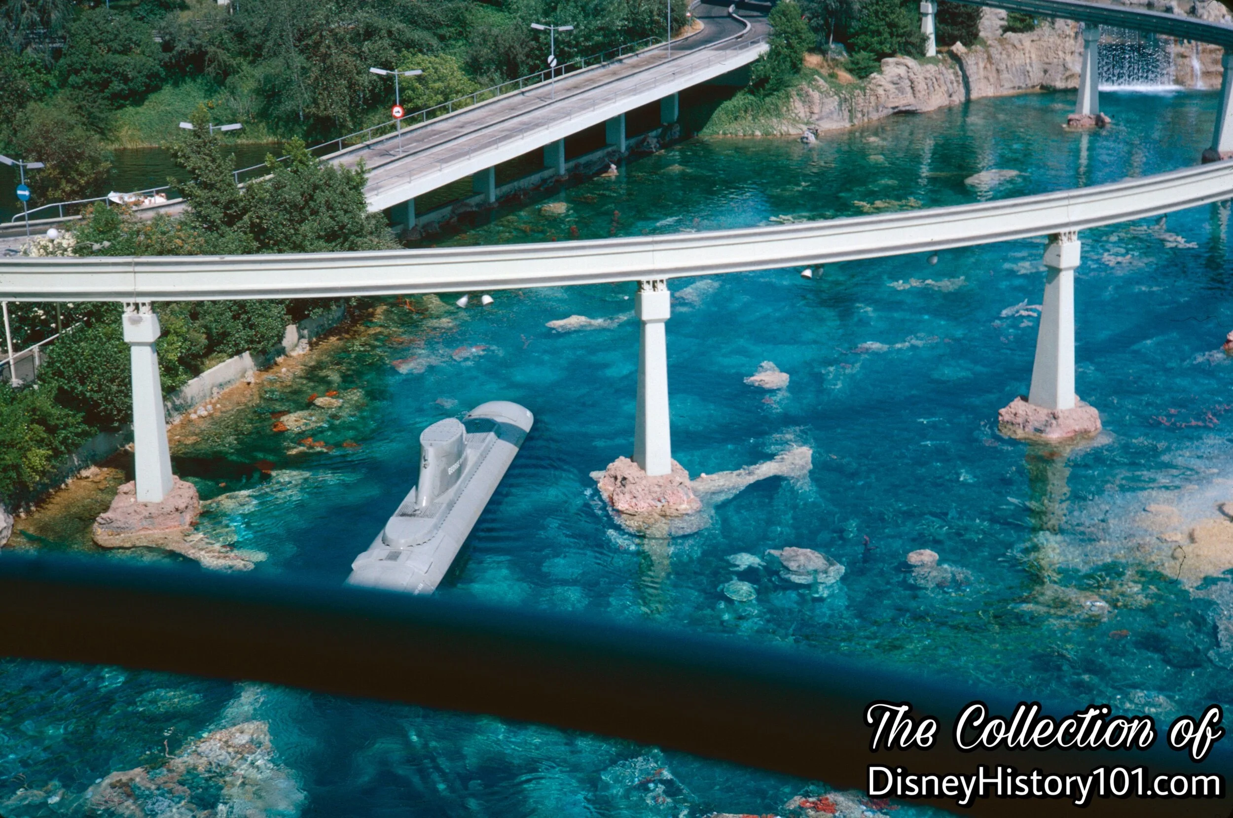 A small section of Monorail pylons carry trains over a portion of the Submarine FRONT/INTERMEDIATE LAGOON, 1962.