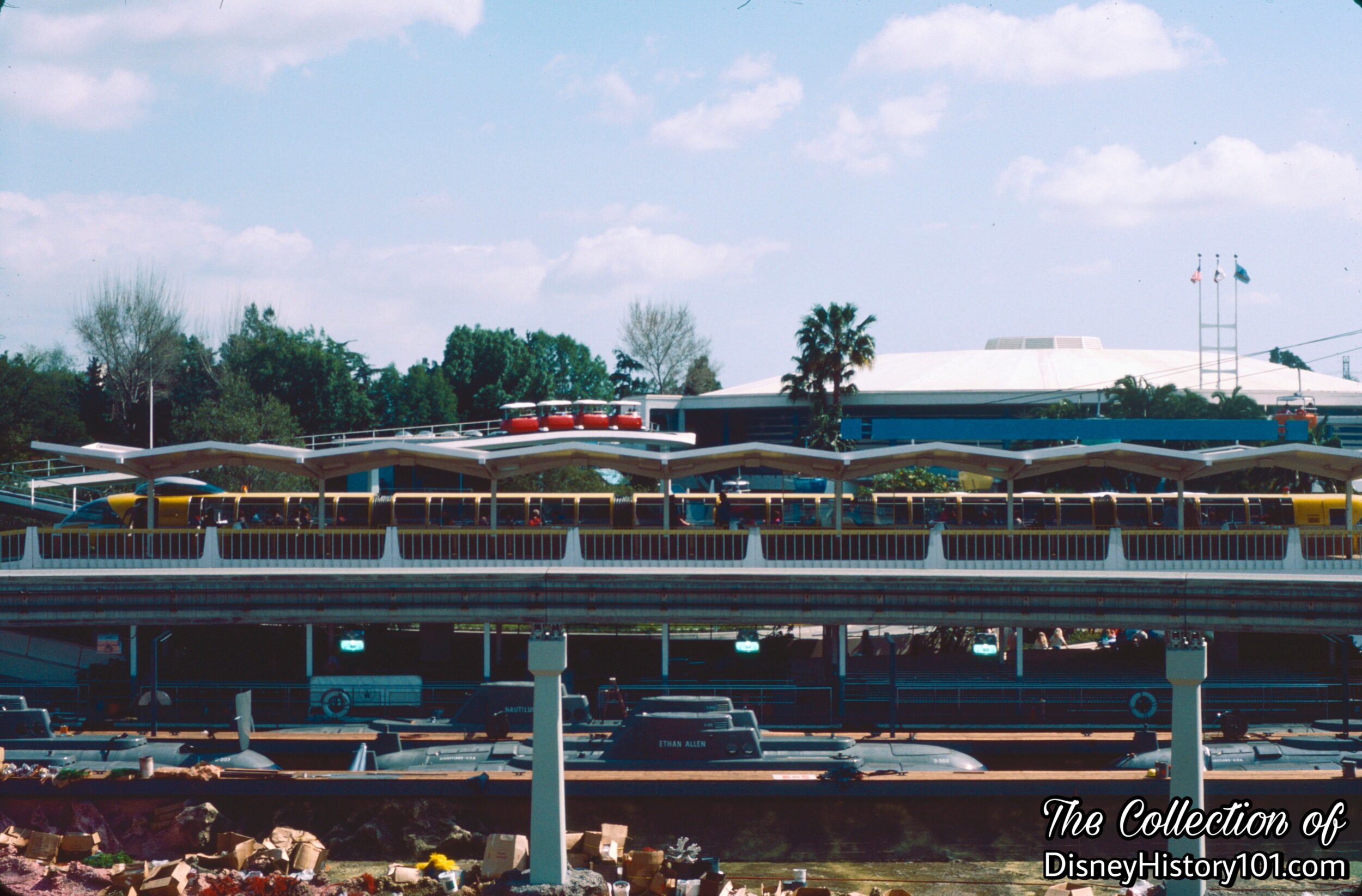 REENTERING THE PARK AND TOMORROWLAND SEGMENT - Monorail Mark V and Monorail Station over the drained Submarine Lagoon.
