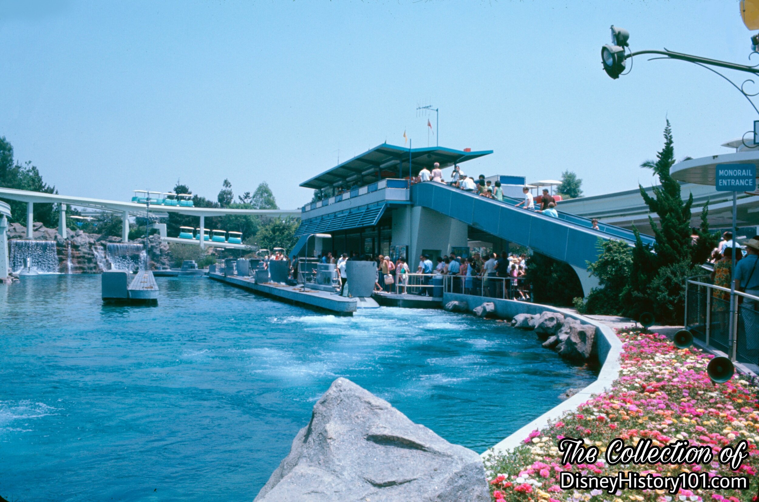 Colorful flowers lead the way to the “Stephens-Adamson Speedramp” at the Tomorrowland Monorail Station.