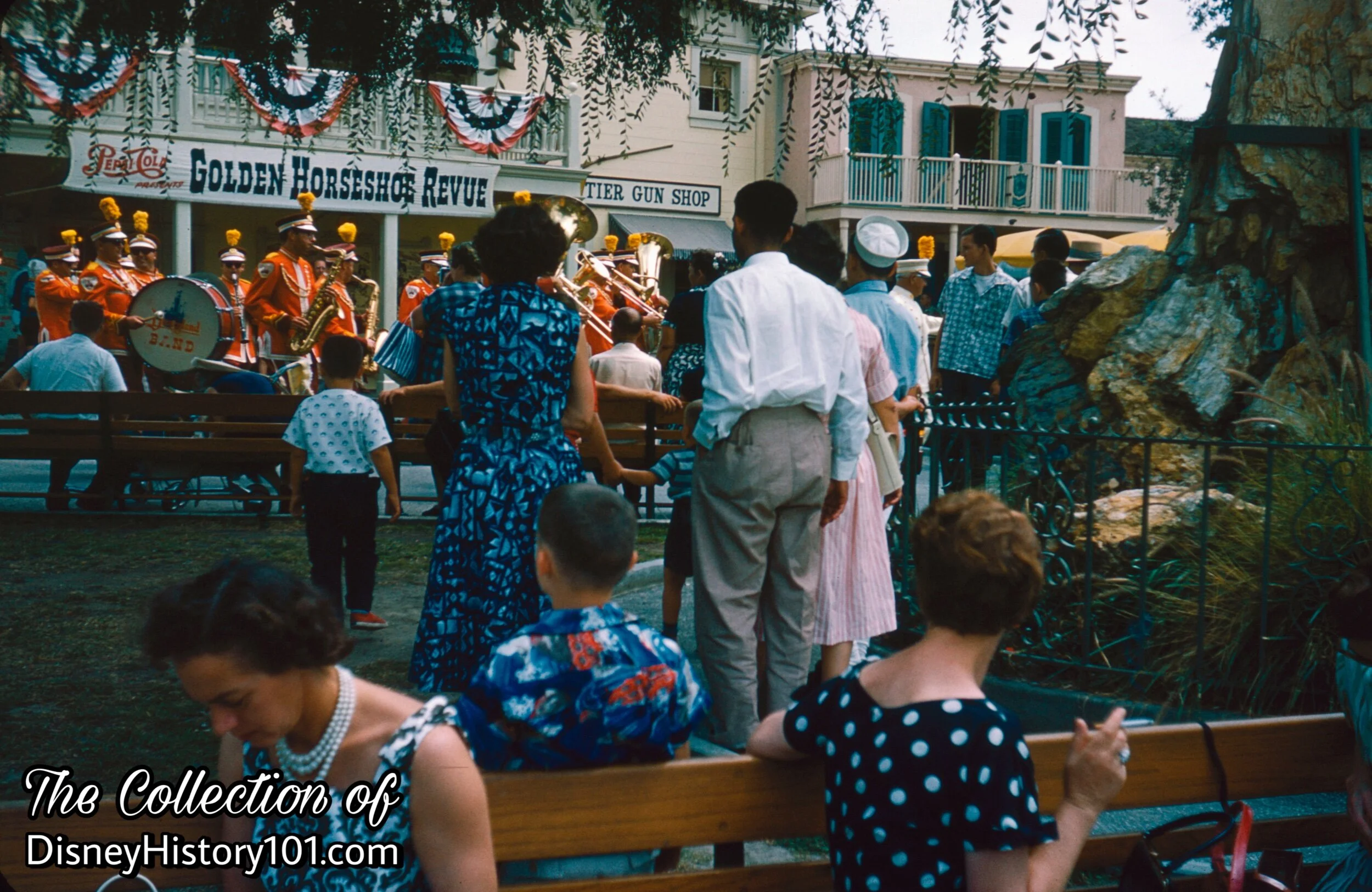 Guests enjoy a concert performed by the Disneyland Marching Band in Frontierland, (August, 1960)