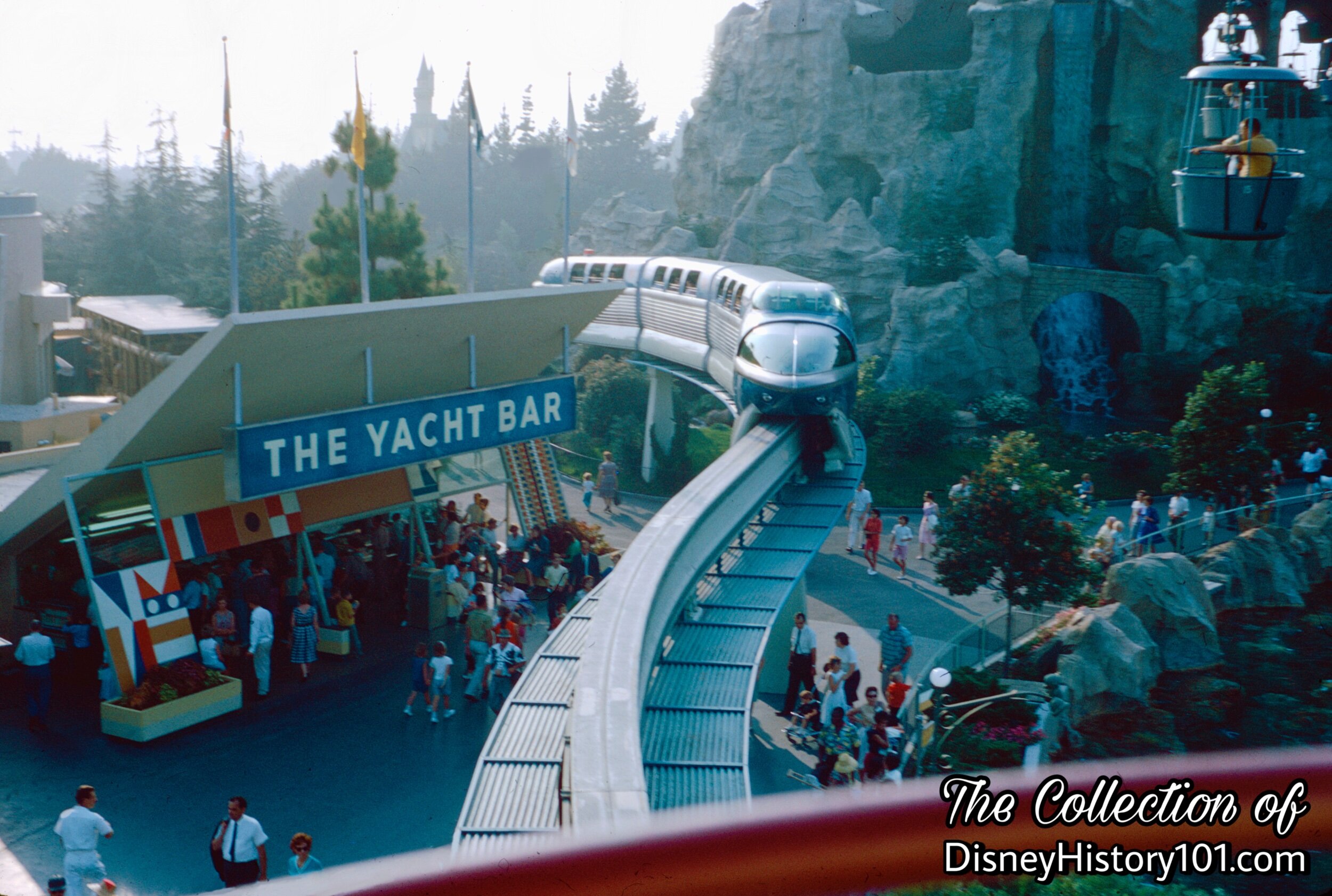 Monorail Blue Mark I passes the Yacht Bar in Tomorrowland.