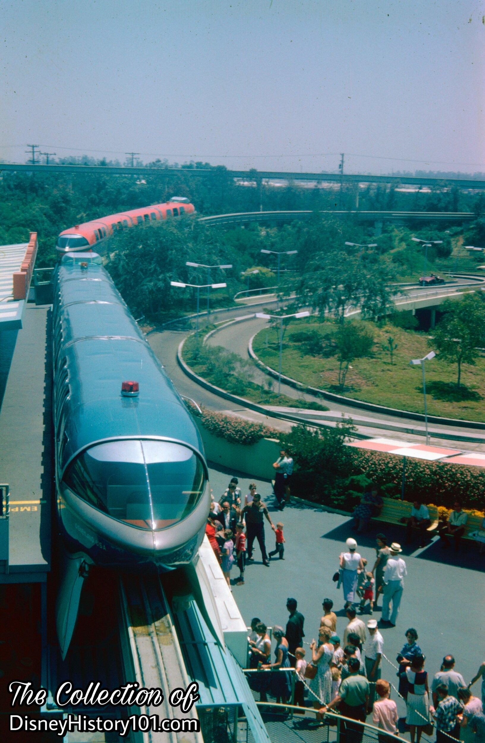 REENTERING THE PARK AND TOMORROWLAND SEGMENT - The dual-coach Monorail Mark II Blue & Monorail Mark II Red.