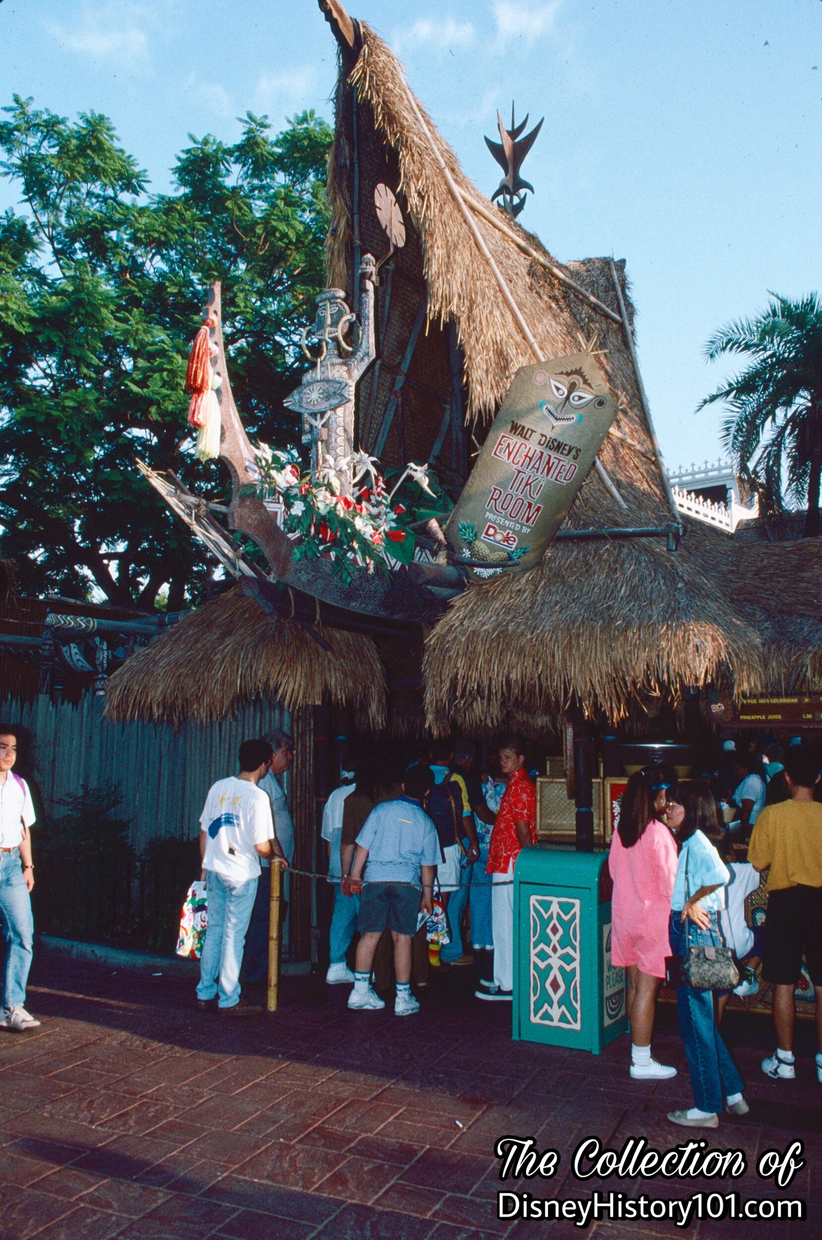 Uti holding her torch over the "A" frame entrance of Walt Disney's Enchanted Tiki Room.