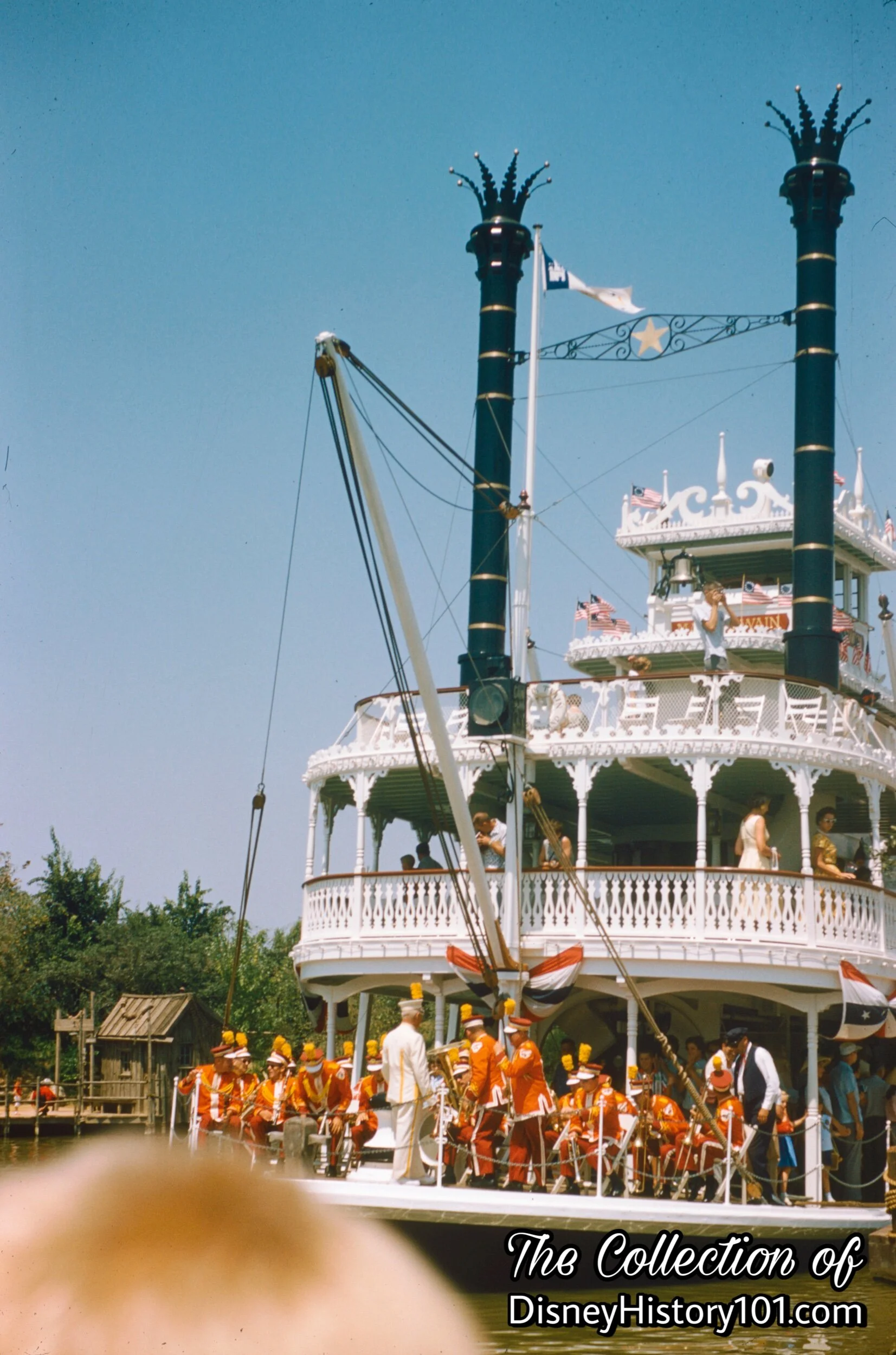 Vesey Walker leads The Disneyland Marching Band in an open-air concert aboard the Mark Twain