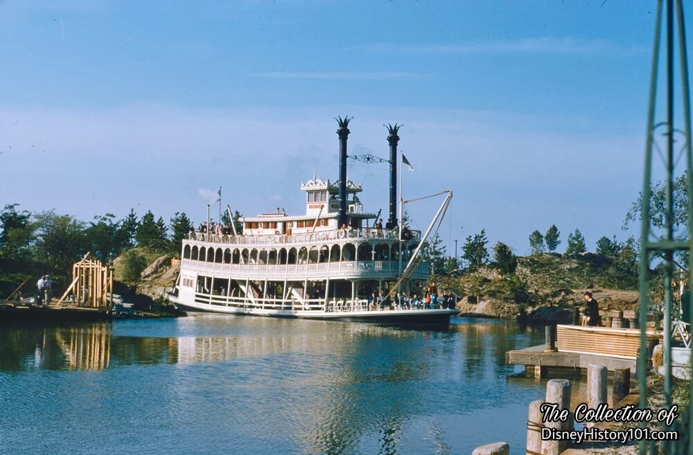 Lumber on the Frontierland Dock is Shipped Across the River, as a Fishing Pier Takes Form