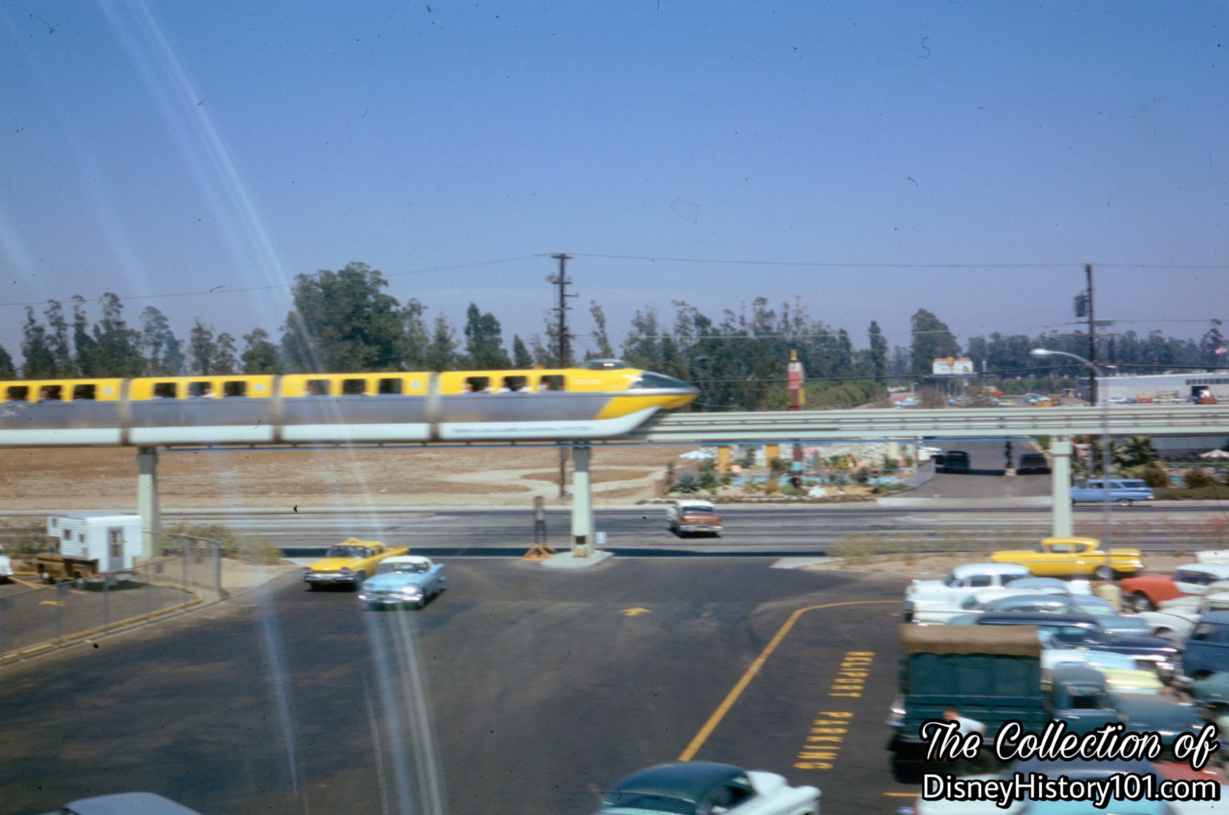 Heliport Parking Lot Area Entrance and the Monorail Mark II Yellow saddling the Beamway overhead, 1961.