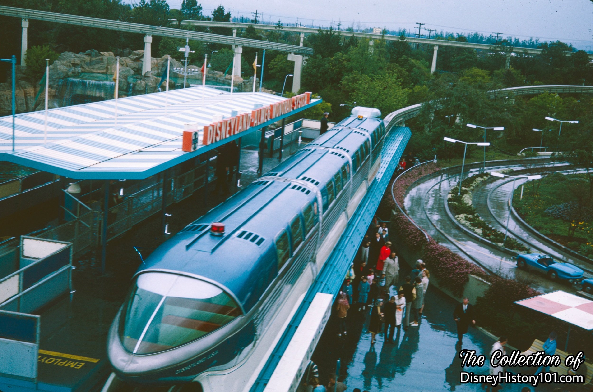 REENTERING THE PARK AND TOMORROWLAND SEGMENT - Monorail Mark II Blue on a rainy day, c.1961.