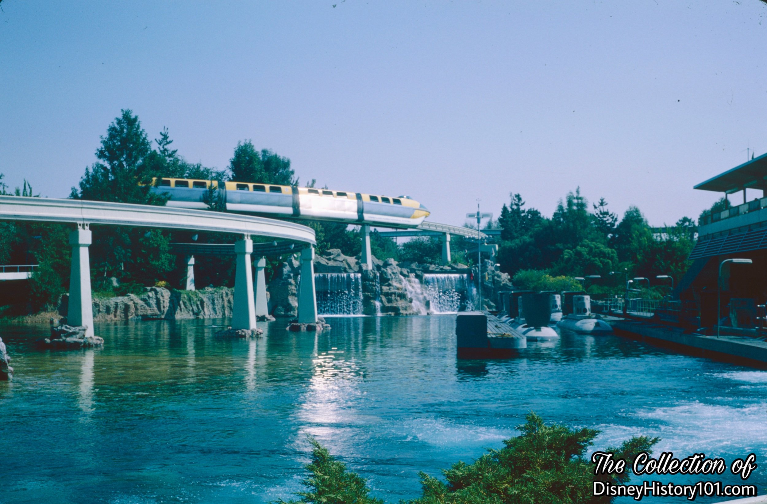 REENTERING THE PARK AND TOMORROWLAND SEGMENT - Monorail Mark II Yellow Reentering the Park, the Monorail reaches its highest point, 31 feet, and affords a spectacular view of Submarine Lagoon, 1965.