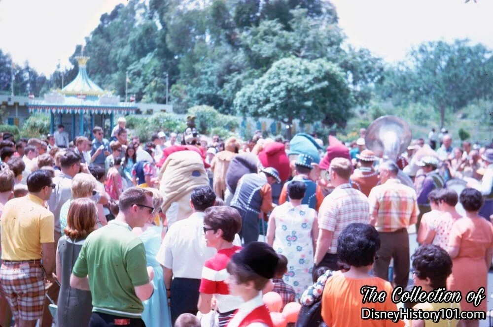A large Fantasyland audience enjoys a show.