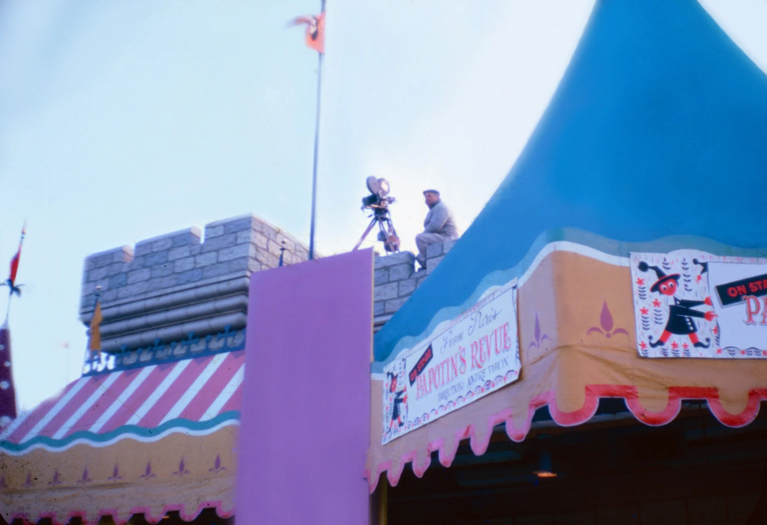 A cameraman with tripod sits poised on the roof of the theater while Papotin’s Revue plays below.