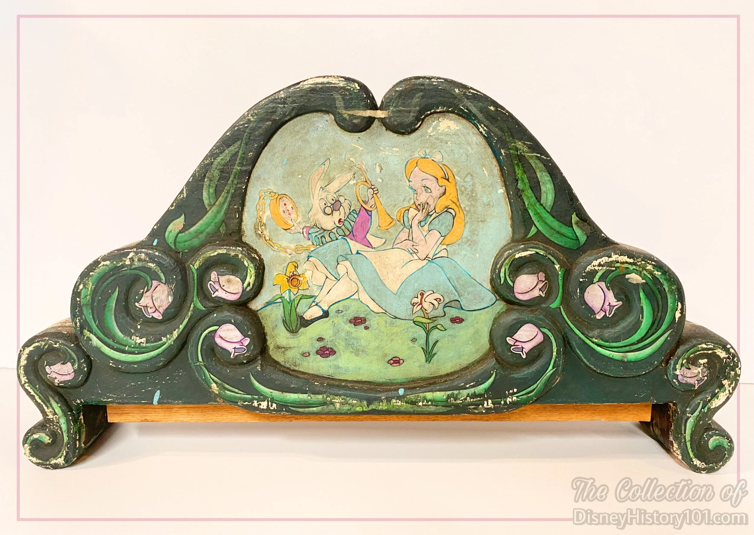 An upper section of an Alice in Wonderland queue sign removed during a rehabilitation, when the signage was looking pretty worn and stressed.
