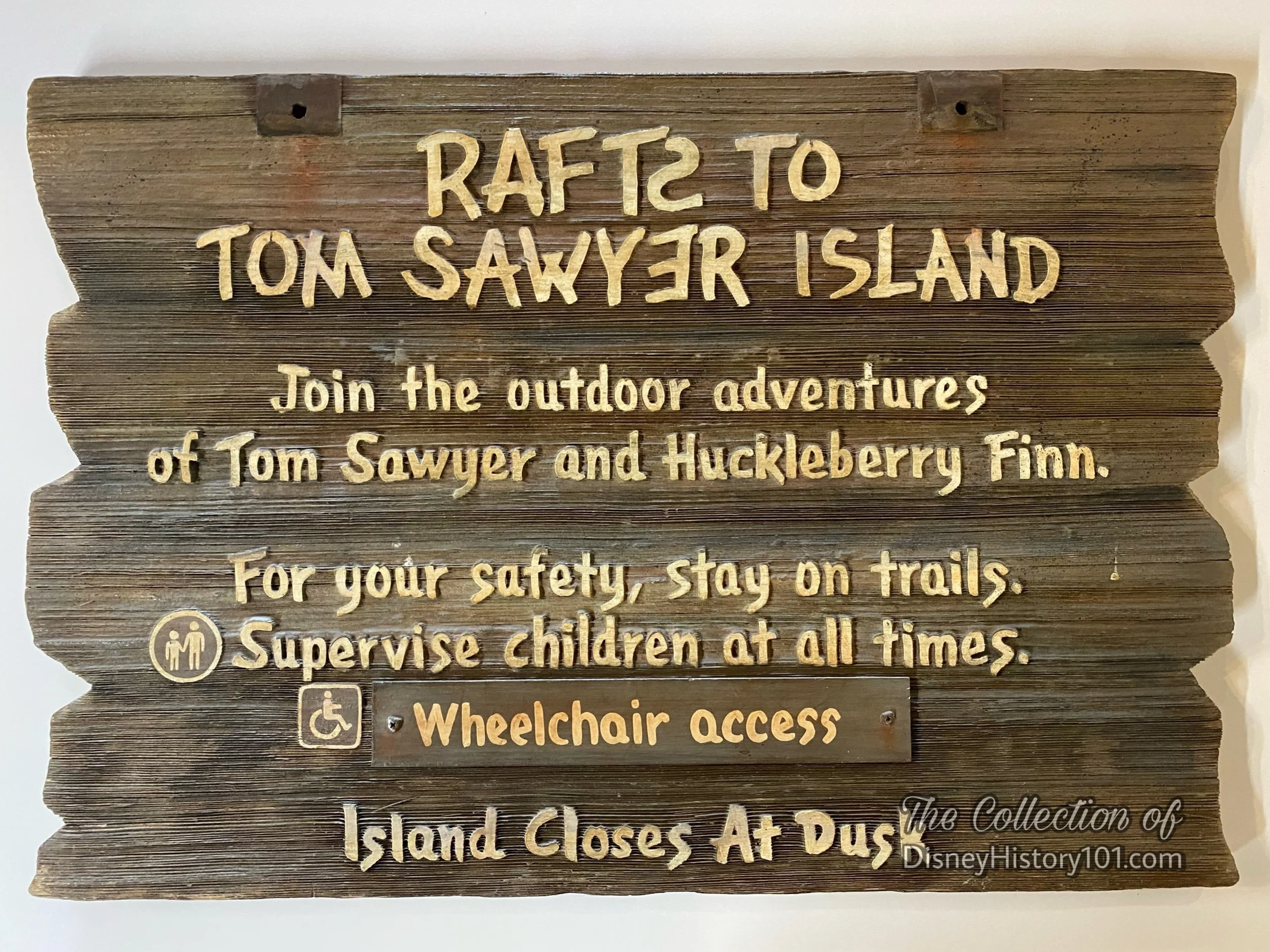  At Disneyland, signs are themed to support the stories with appropriate graphics, colors, fonts, terminology, overall design of the sign, materials (wood, metal, banners, etc.), and verbiage used on the signage. The character of these signs have bee