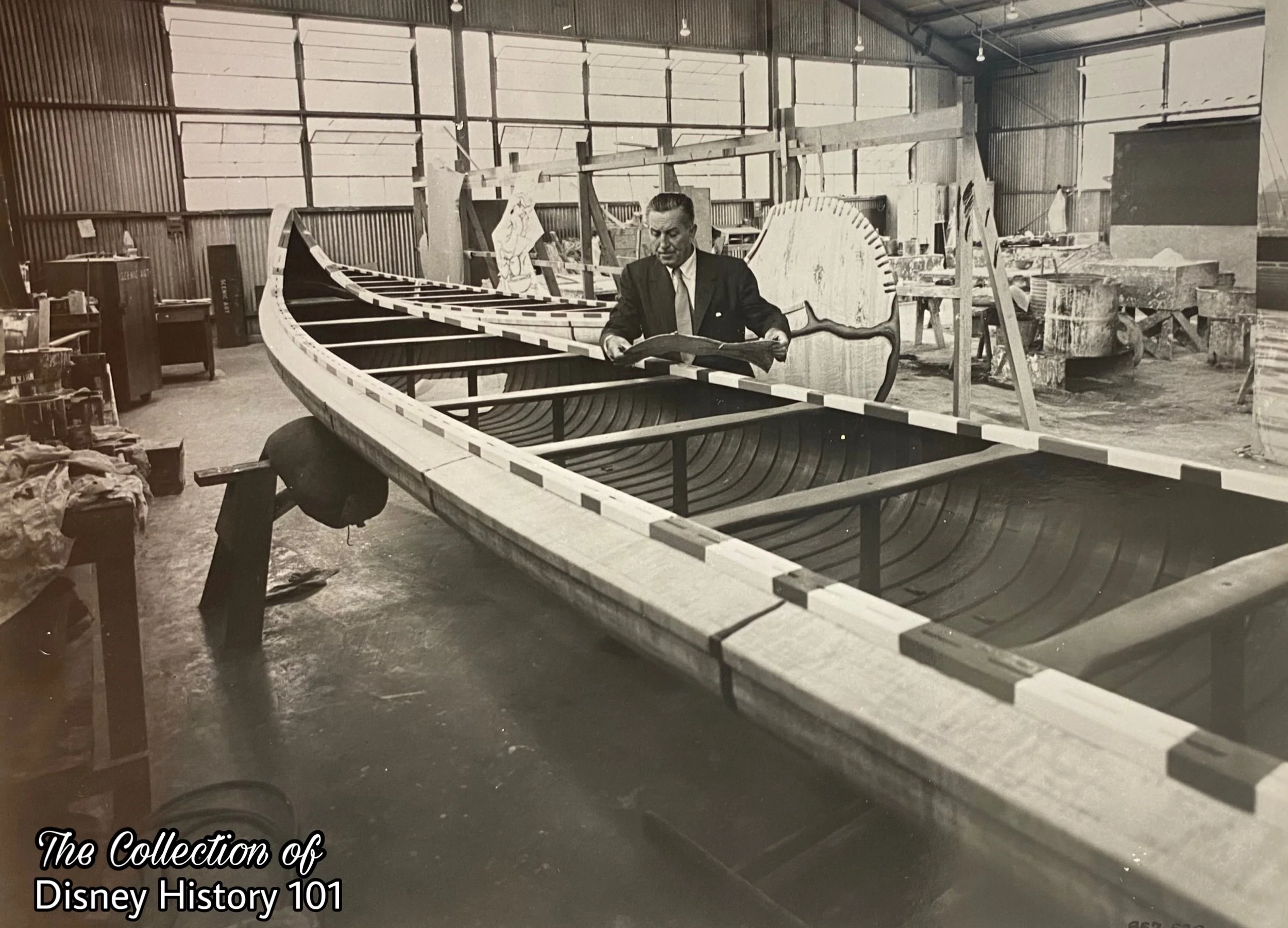 Walt Disney inspects a canoe belonging to the second fleet of Indian War Canoes at Walt Disney Studios.