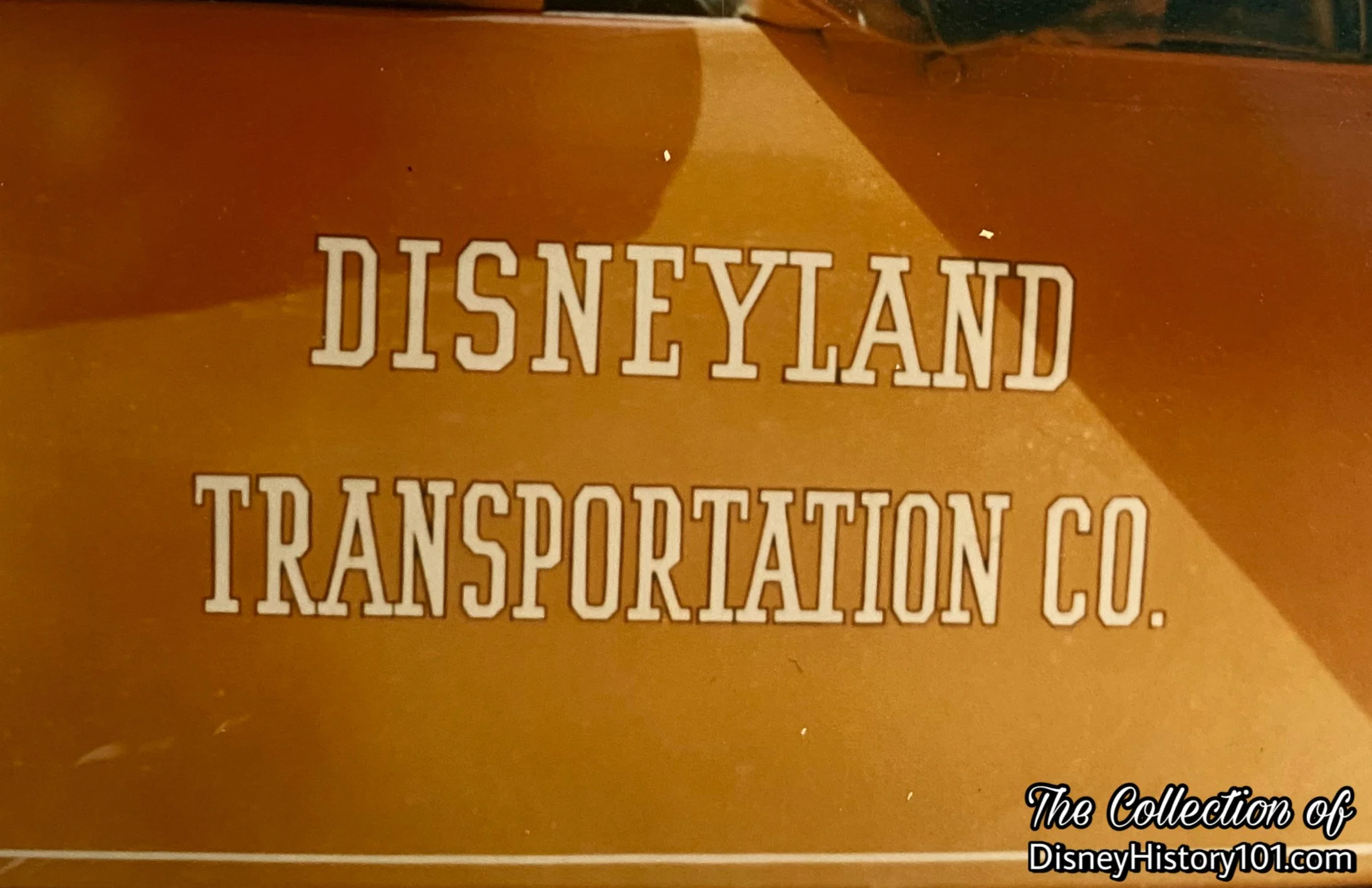 Disneyland Documentational Image focusing on the “Disneyland Transportation Co.” signage on the Horseless Carriage.