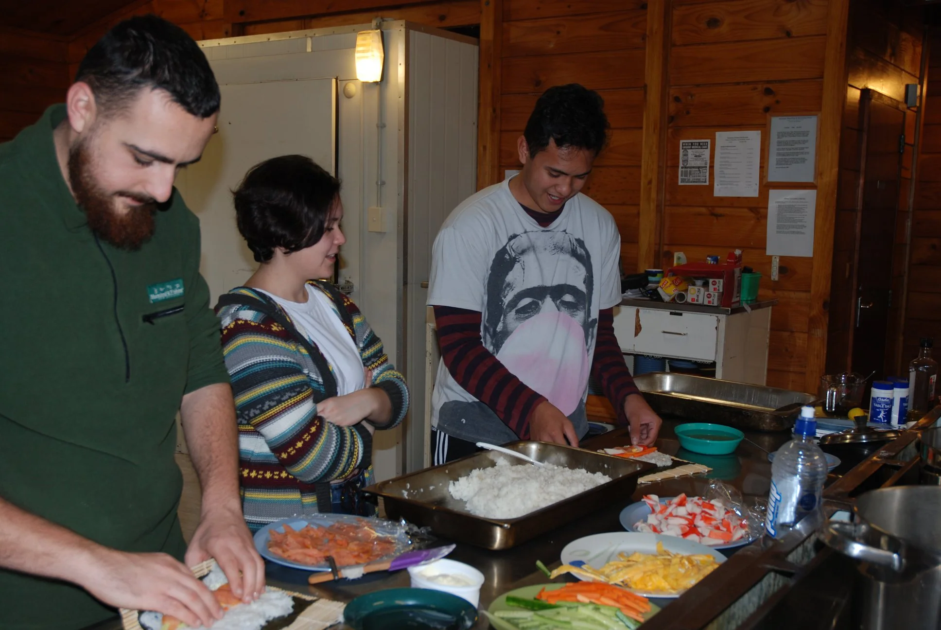 Participants learn to roll sushi during an arts workshop