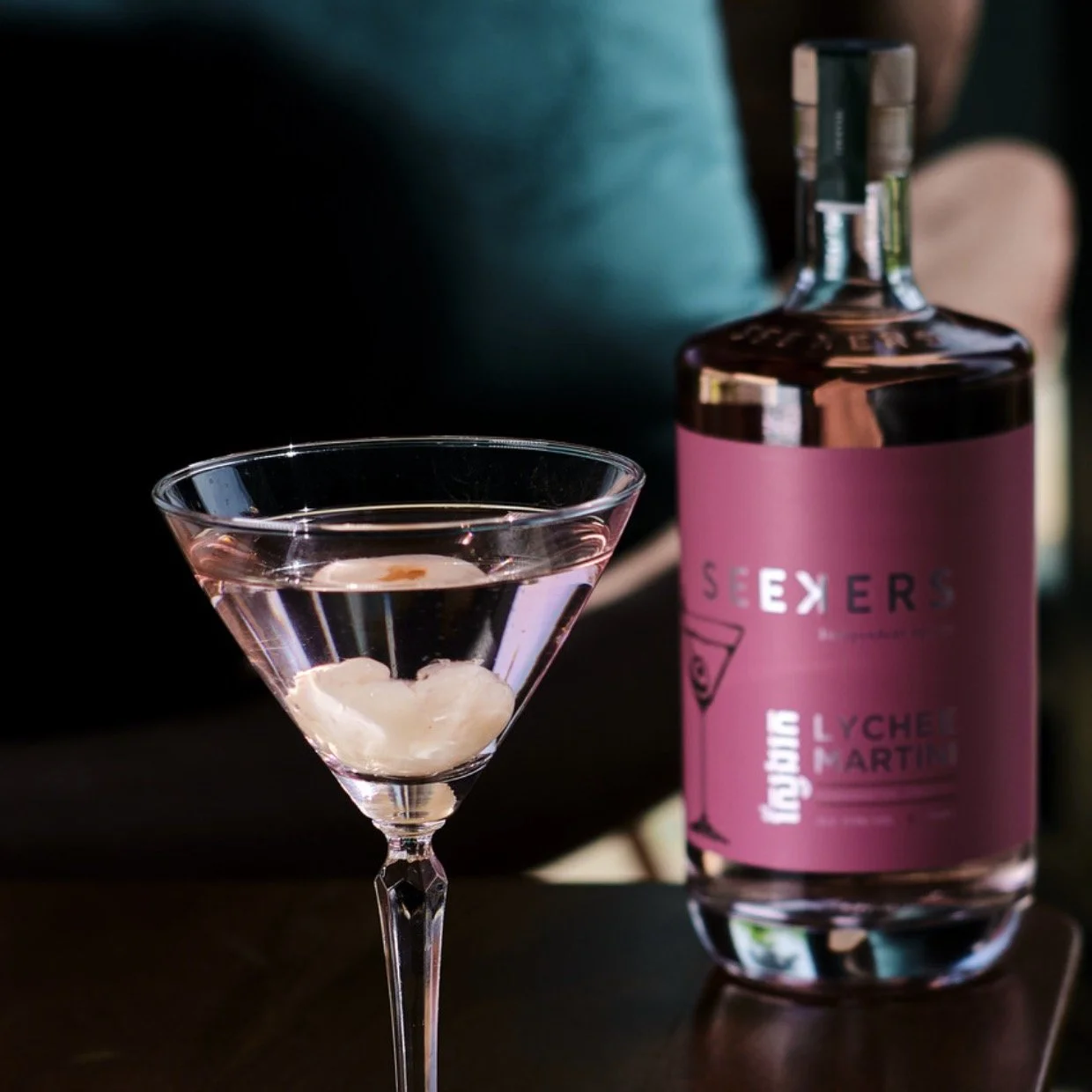 Seekers Lychee Martini bottle with a poured martini and lychee garnish
