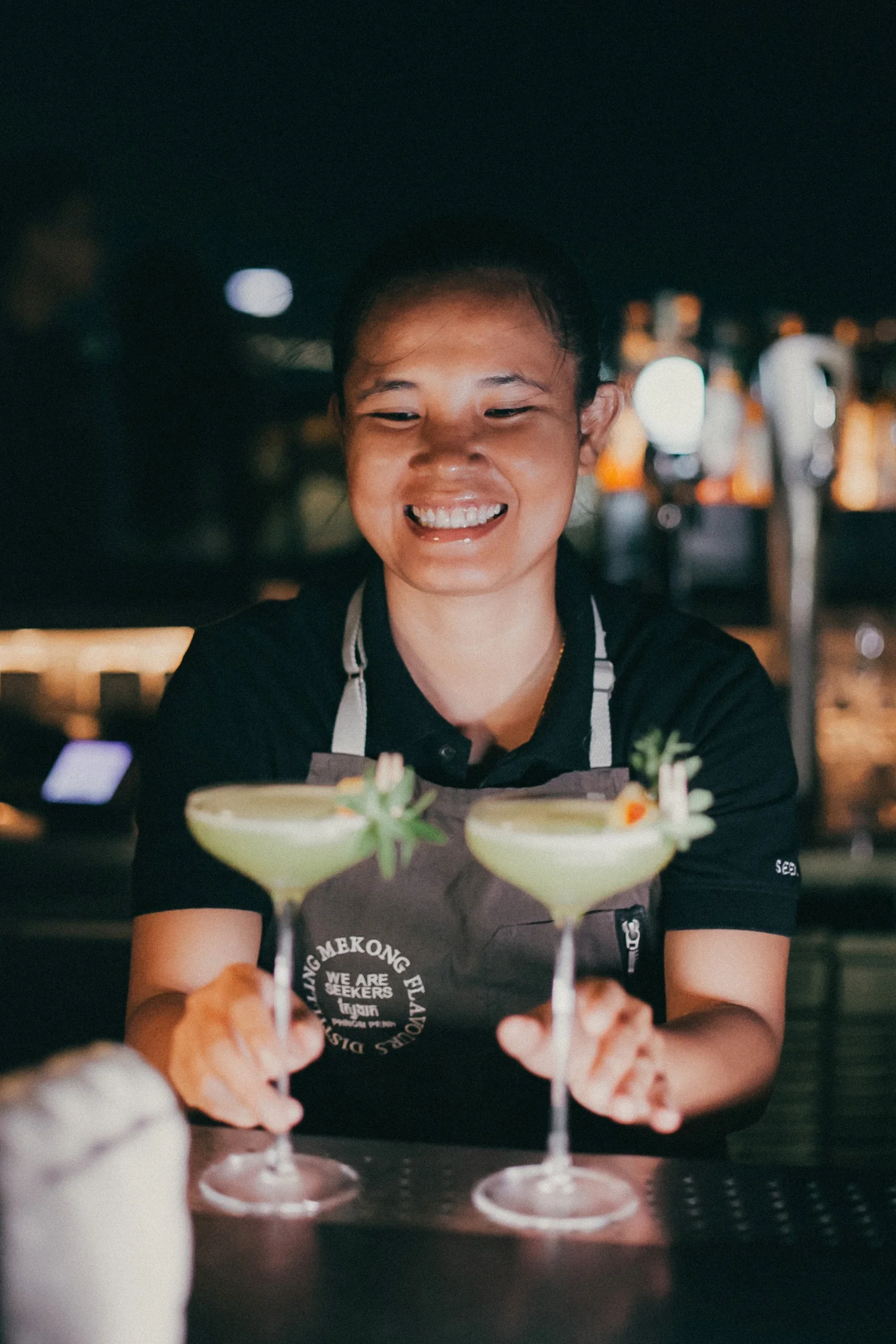 A Seekers bartender serving cocktails