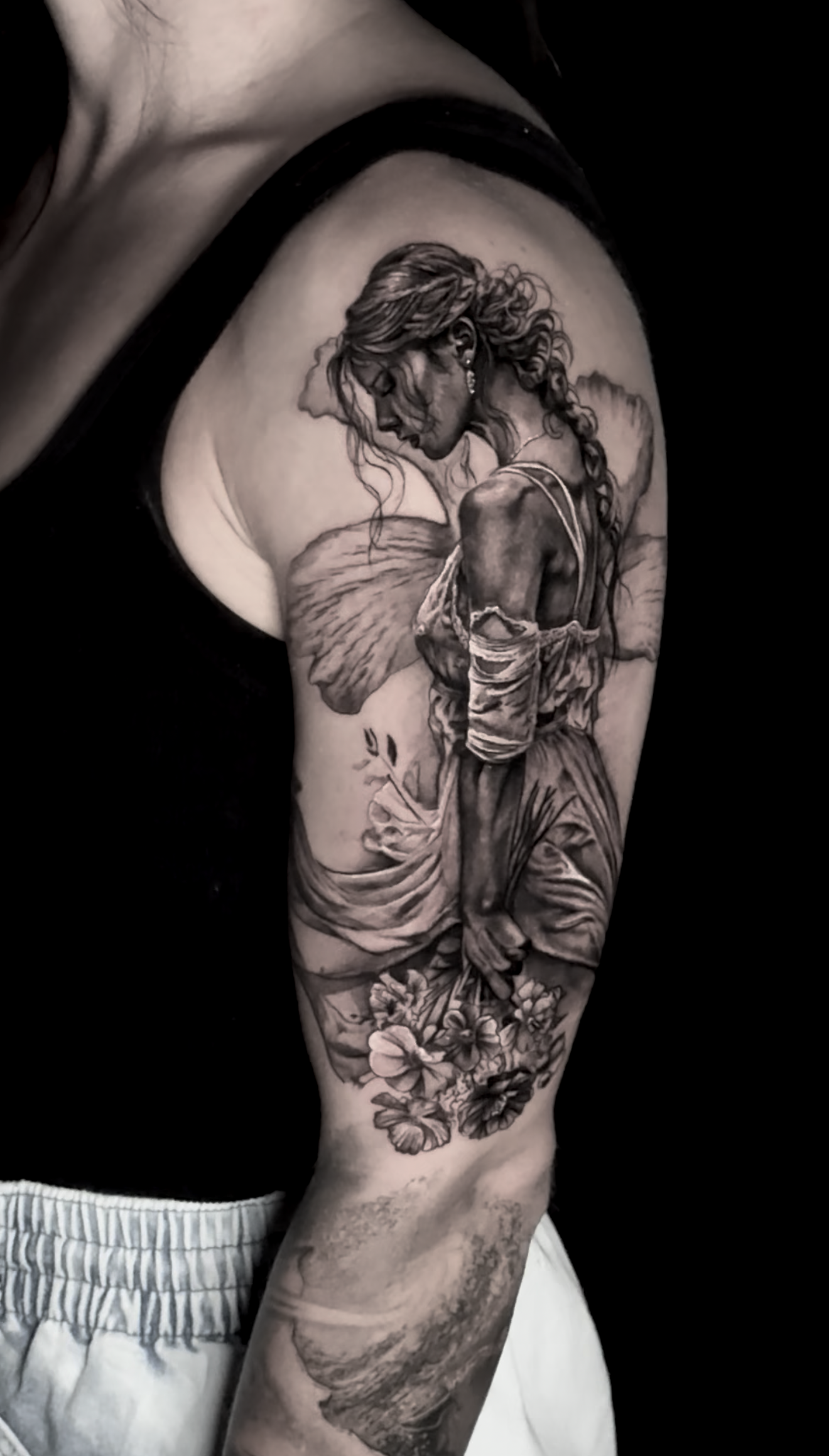 black-and-grey-realism-woman-withflowers-tattoo.png