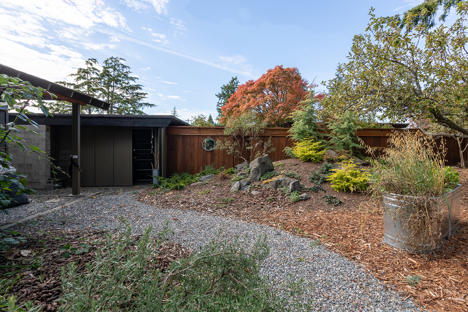  A shed sits at the edge of the property, adjacent to the neighbor’s carport and fence. “We wanted a sense of seclusion and space, but we didn’t want to feel isolated, or close off our neighbors.” 