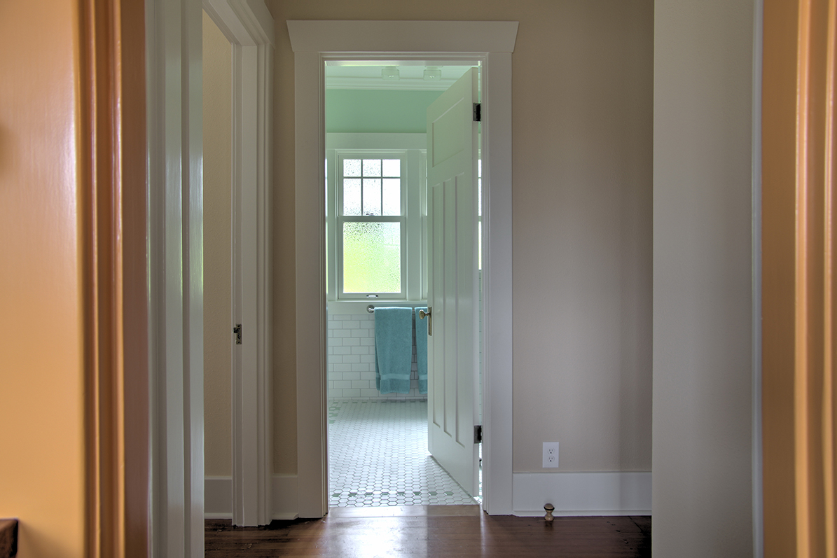  The new entry and windows in the bathroom capture more light and fresh air that spills into the hallway. 