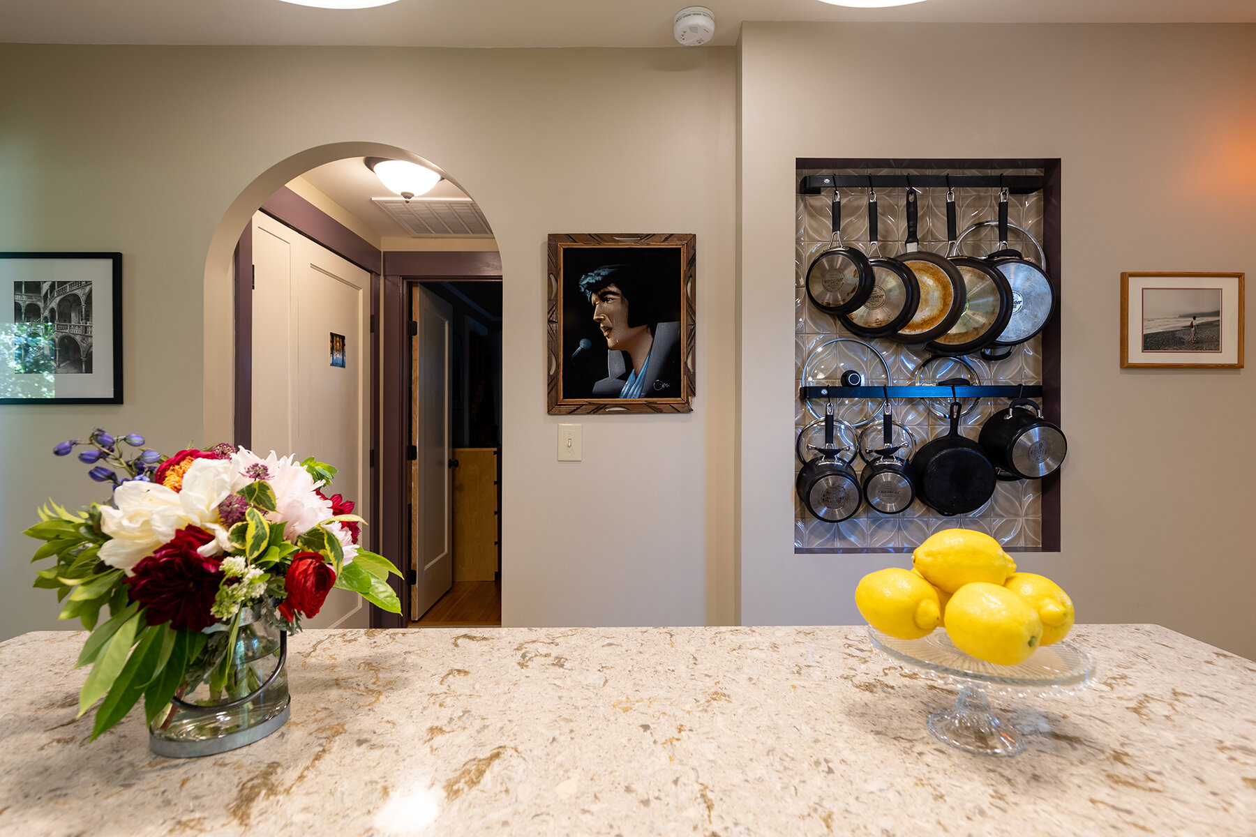  A beloved pot rack found a home in a new niche that saves on cabinet space without disrupting sightlines or head space.      