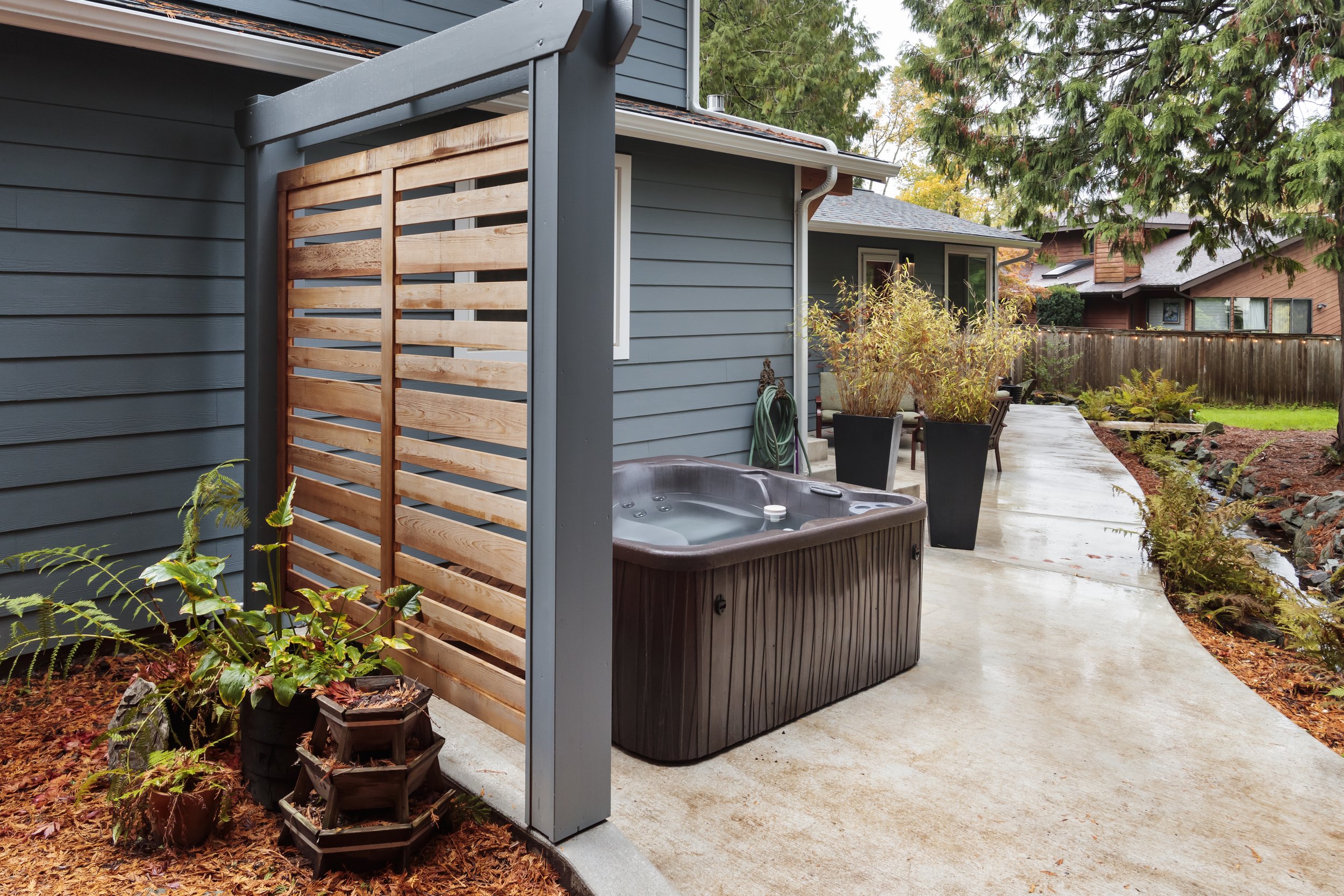  A simple screen defines the hot tub area and lends privacy.  