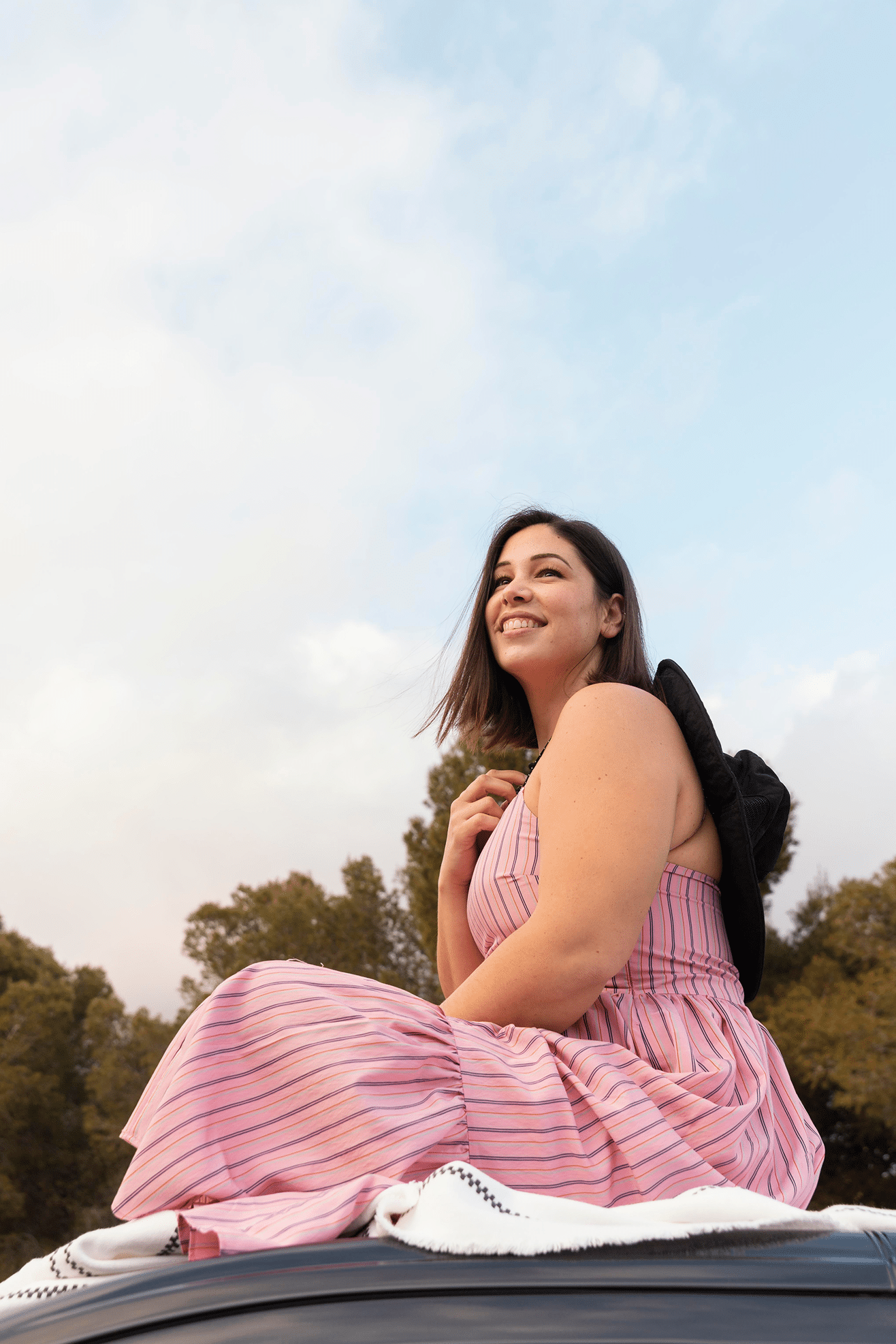 Woman sitting outdoors feeling confident and at ease in her body, reflecting growth and healing through body image therapy