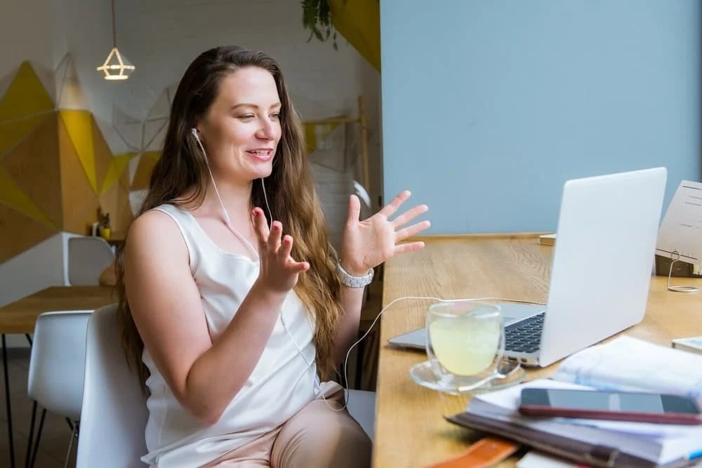Woman engaging in online eating disorder therapy on a laptop, receiving virtual mental health support