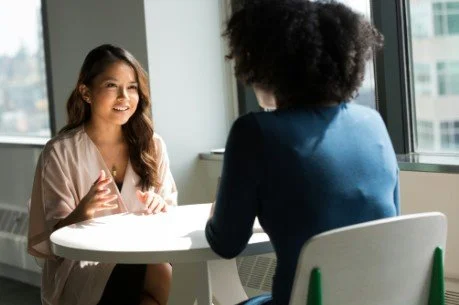 Couple having a thoughtful conversation over coffee, representing communication, emotional support, and relationship challenges during eating disorder recovery.