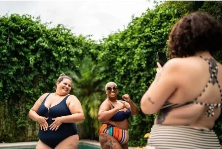 Three plus sized woman have a photoshoot while near the pool. Learn how body image therapy in California can help you accept your body image. Search for an eating disorder therapist Orange County or Body image issues in California today.