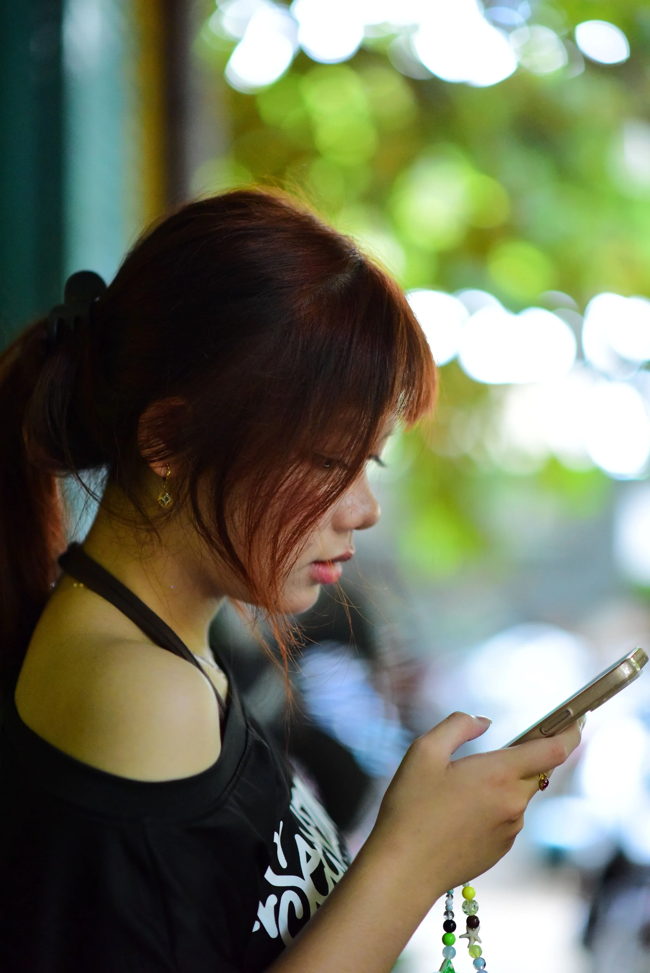 Young woman scrolling through social media on her phone, illustrating how social media can influence body image, self-esteem, and mental well-being.