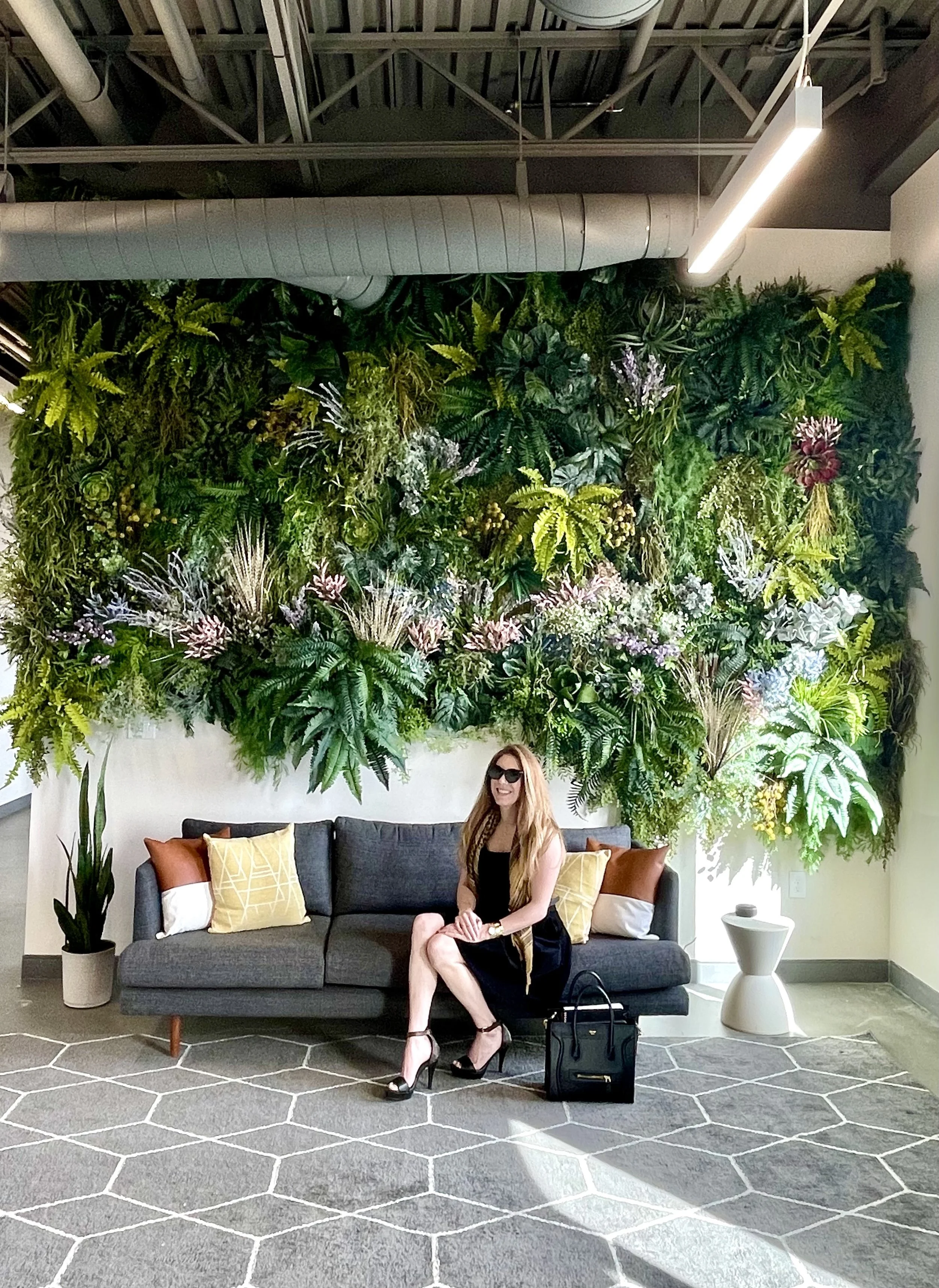 Idaho Ambassador in front of her custom plant wall art installation at Modern Lending